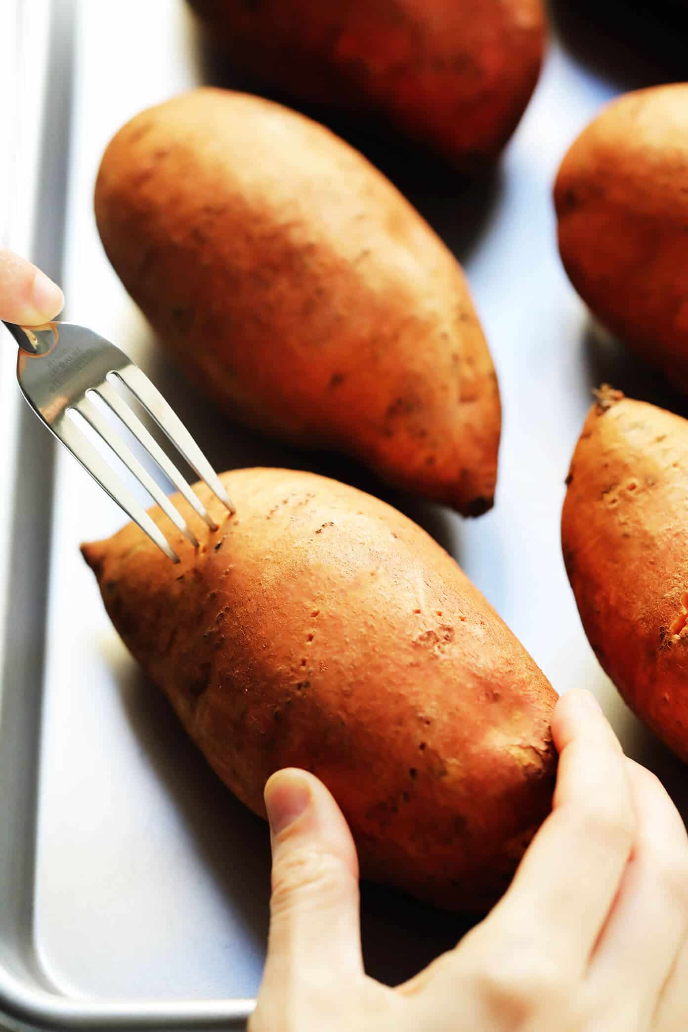 My favorite method for how to bake sweet potatoes in the oven that are perfectly crispy on the outside and soft on the inside. Plus, lots of ideas for loaded potato toppings you can add on too! | gimmesomeoven.com #sweetpotato #healthy #glutenfree #vegan #vegetarian #dinner #side Poke Sweet Potatoes Before Baking