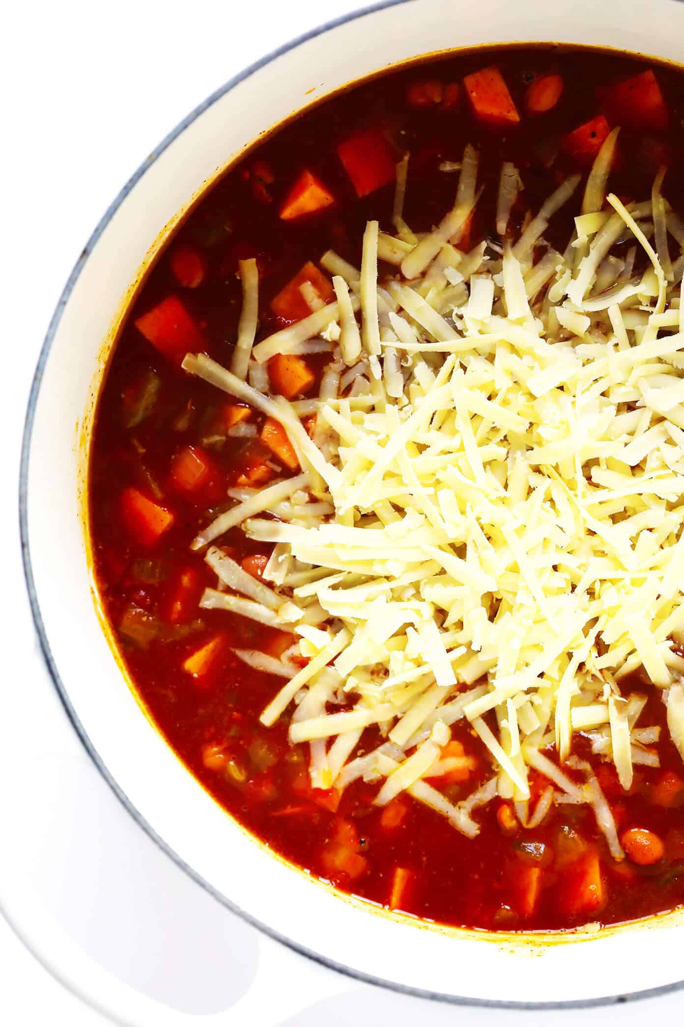 This sweet potato enchilada soup is easy to make, full of rich cheesy enchilada flavors, and SO cozy and comforting. Load this vegetarian chili up with avocado, cilantro, tortilla chips, or any of your favorite toppings and enjoy! | gimmesomeoven.com #sweetpotato #soup #chili #enchilada #taco #cheesy #stew #crockpot #dinner #healthy #freezermeal #vegetarian #vegan #glutenfree Cheesy Sweet Potato Enchilada Soup Recipe