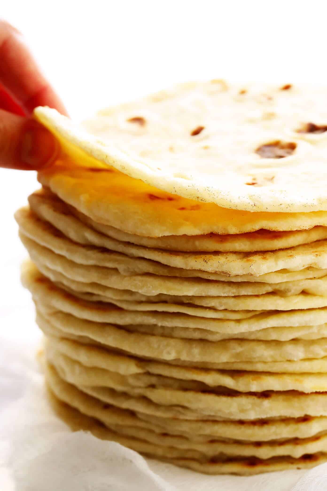 My favorite homemade flour tortillas are irresistibly soft, chewy, thick, and flavorful -- and easy to make with just 5 ingredients (no lard)! Perfect for tacos, burritos, enchiladas, quesadillas, and naturally vegan too! | gimmesomeoven.com #flour #tortillas #mexican #texmex #easy #tacos #enchiladas #burrito #homemade #diy #mealprep Flour Tortillas