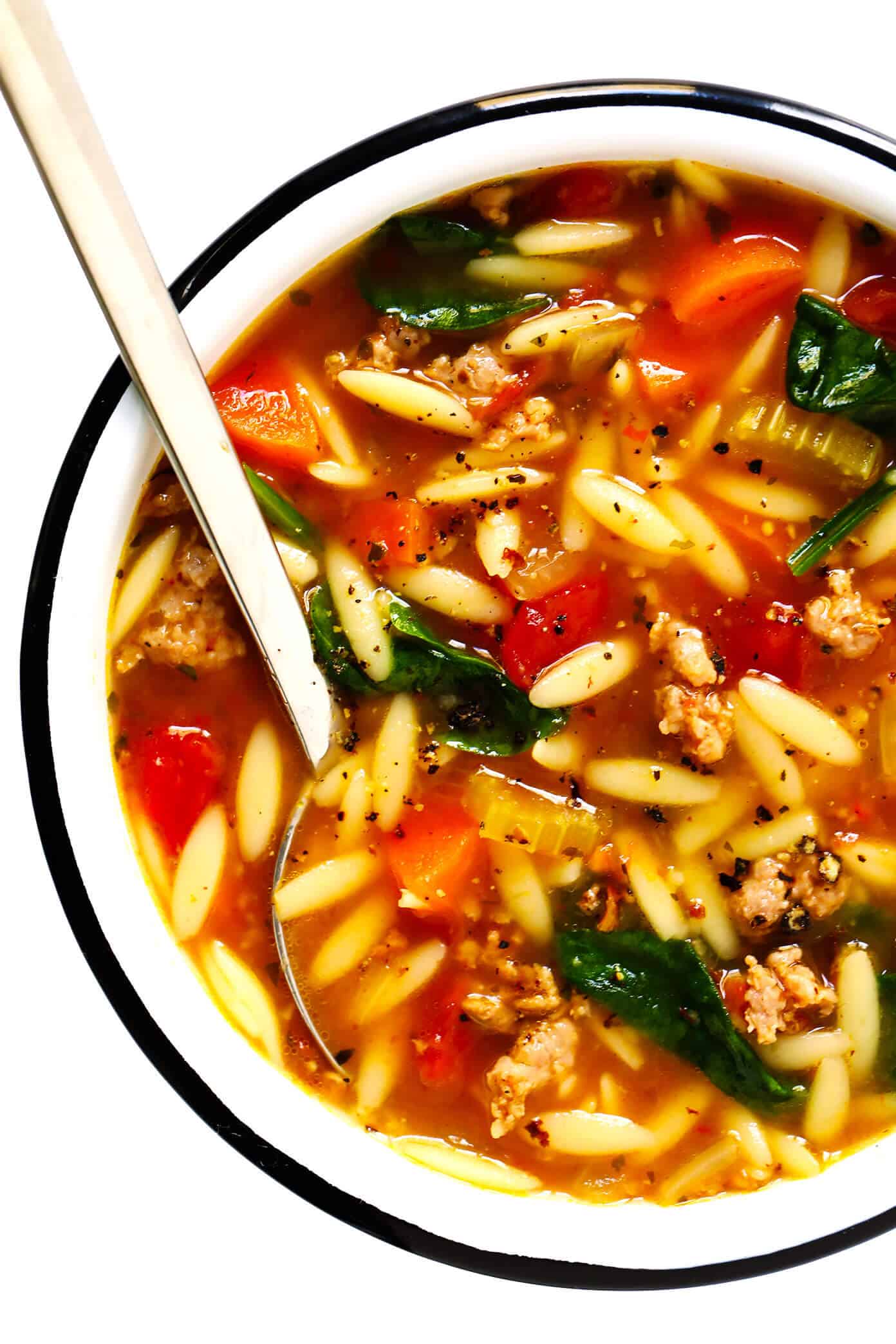 This Italian Sausage and Orzo Soup recipe is easy to make with your choice of veggies, it's seasoned with a zesty garlic tomato broth, and tastes SO cozy and comforting. The perfect easy dinner recipe that also makes great leftovers for later! | gimmesomeoven.com #italian #soup #pasta #orzo #sausage #dinner #freezermeal #mealprep #healthy Italian Sausage, Orzo and Spinach Soup Recipe