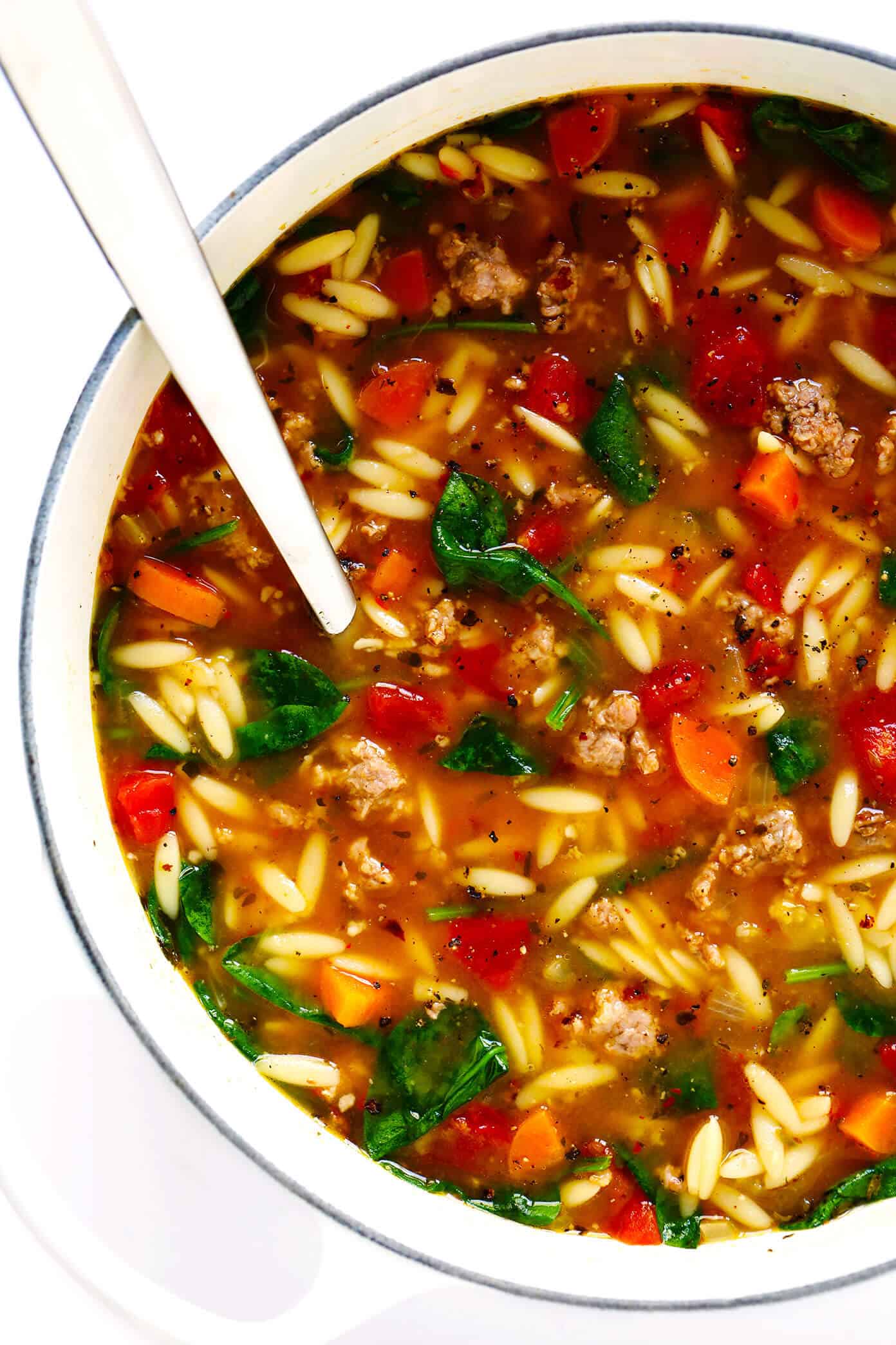 This Italian Sausage and Orzo Soup recipe is easy to make with your choice of veggies, it's seasoned with a zesty garlic tomato broth, and tastes SO cozy and comforting. The perfect easy dinner recipe that also makes great leftovers for later! | gimmesomeoven.com #italian #soup #pasta #orzo #sausage #dinner #freezermeal #mealprep #healthy Italian Sausage Orzo Soup Recipe