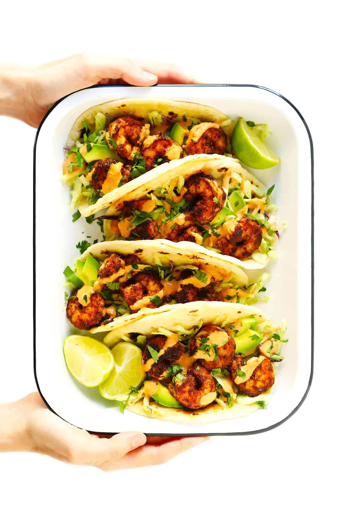 The BEST shrimp tacos recipe! Made with zesty shrimp, cilantro lime coleslaw, sliced avocado and spicy chipotle crema. Kick them up a notch with homemade flour tortillas too, if you'd like! | gimmesomeoven.com #shrimp #tacos #dinner #mexican #seafood #avocado #slaw #sauce Easy Shrimp Tacos Recipe
