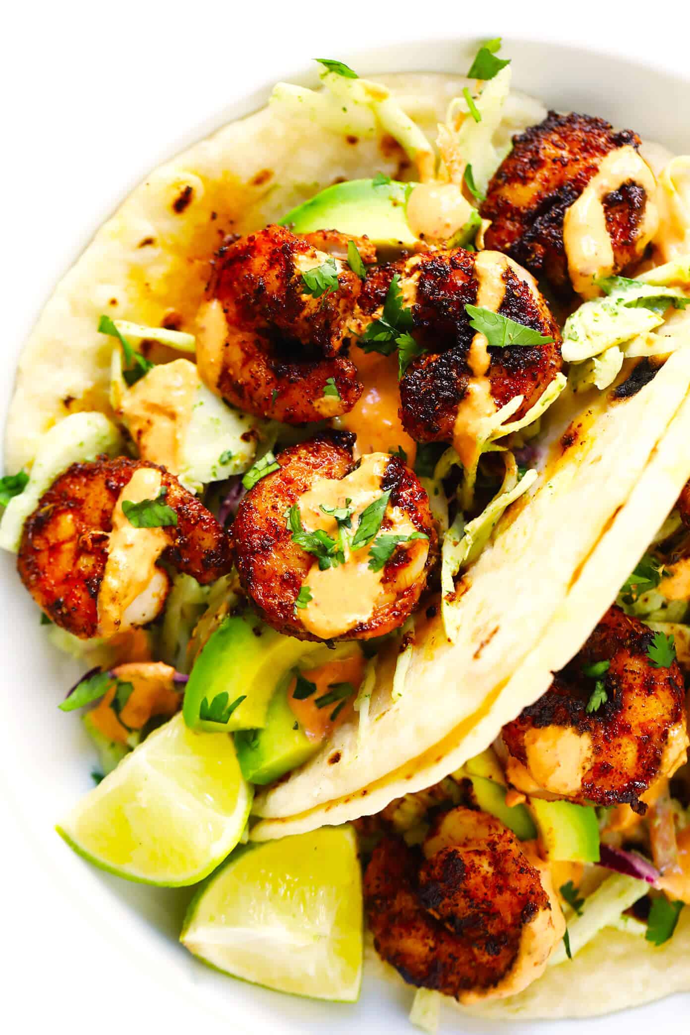 The BEST shrimp tacos recipe! Made with zesty shrimp, cilantro lime coleslaw, sliced avocado and spicy chipotle crema. Kick them up a notch with homemade flour tortillas too, if you'd like! | gimmesomeoven.com #shrimp #tacos #dinner #mexican #seafood #avocado #slaw #sauce Best Shrimp Tacos with Cilantro Lime Slaw, Avocado and Chipotle Crema