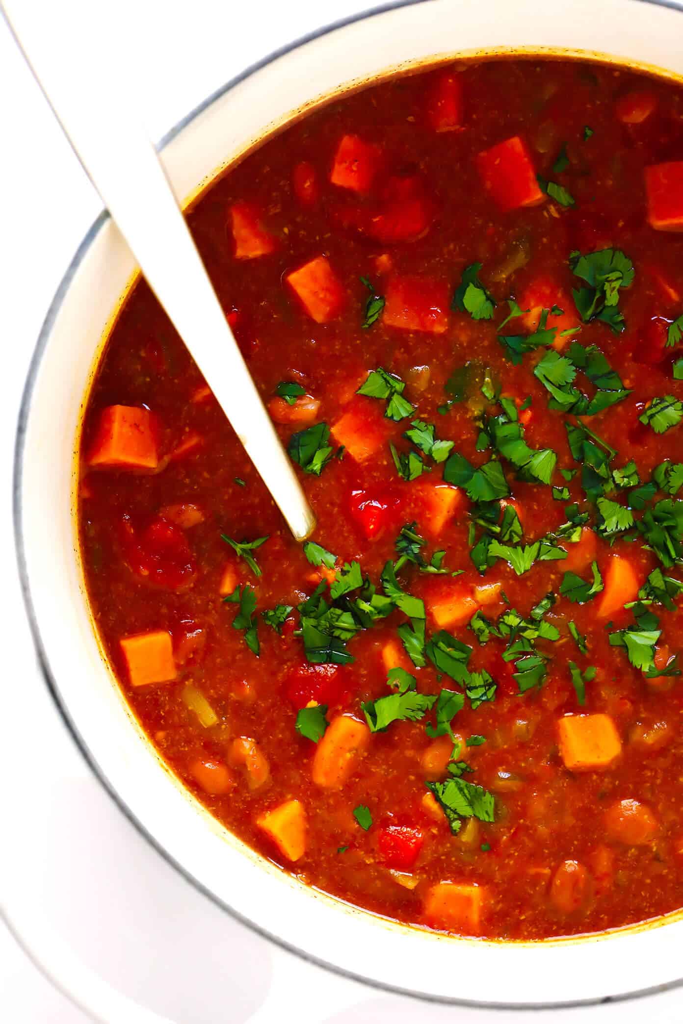 This sweet potato enchilada soup is easy to make, full of rich cheesy enchilada flavors, and SO cozy and comforting. Load this vegetarian chili up with avocado, cilantro, tortilla chips, or any of your favorite toppings and enjoy! | gimmesomeoven.com #sweetpotato #soup #chili #enchilada #taco #cheesy #stew #crockpot #dinner #healthy #freezermeal #vegetarian #vegan #glutenfree Vegetarian Sweet Potato Chili Recipe