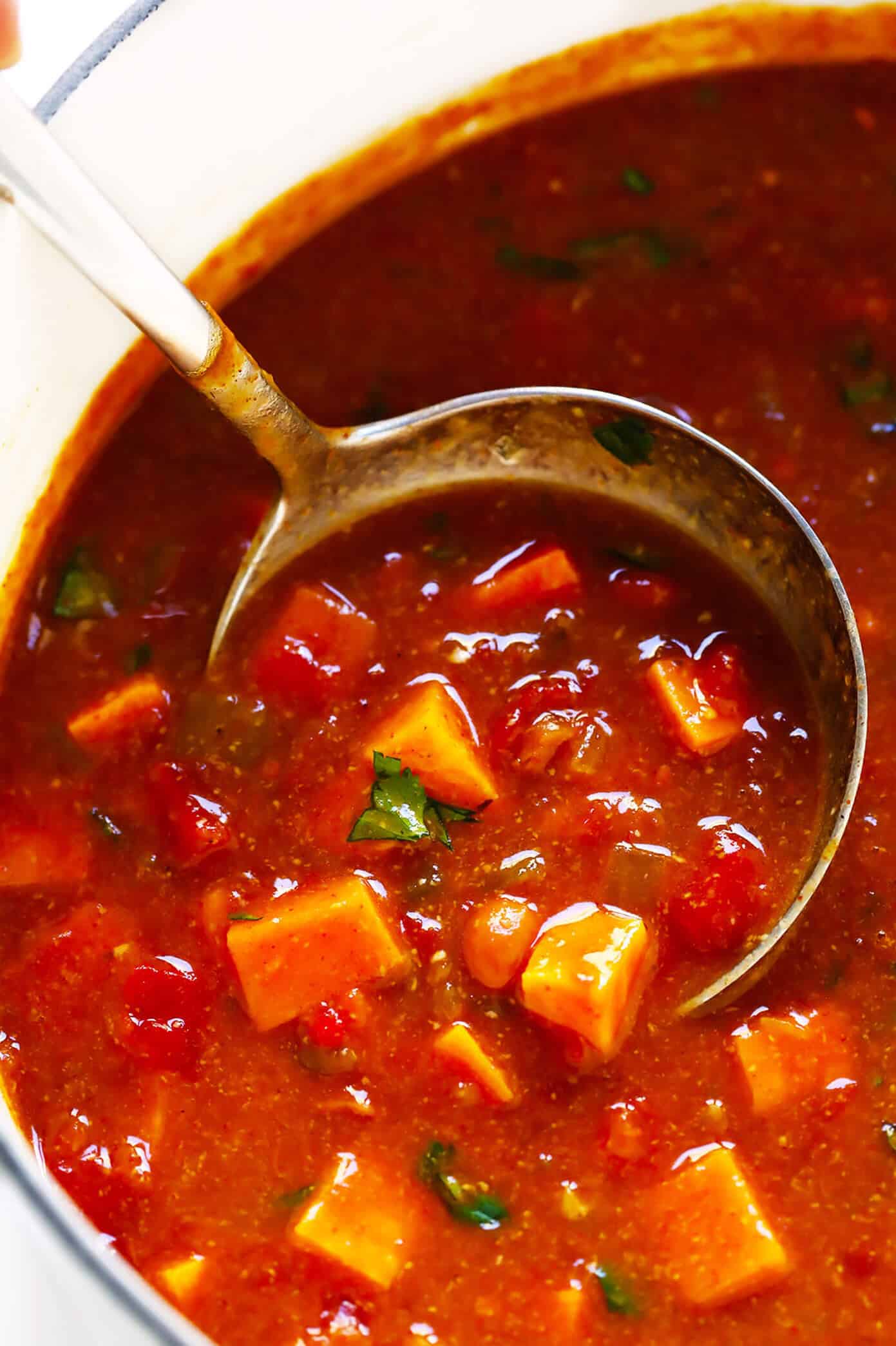 This sweet potato enchilada soup is easy to make, full of rich cheesy enchilada flavors, and SO cozy and comforting. Load this vegetarian chili up with avocado, cilantro, tortilla chips, or any of your favorite toppings and enjoy! | gimmesomeoven.com #sweetpotato #soup #chili #enchilada #taco #cheesy #stew #crockpot #dinner #healthy #freezermeal #vegetarian #vegan #glutenfree Sweet Potato Enchilada Soup Recipe