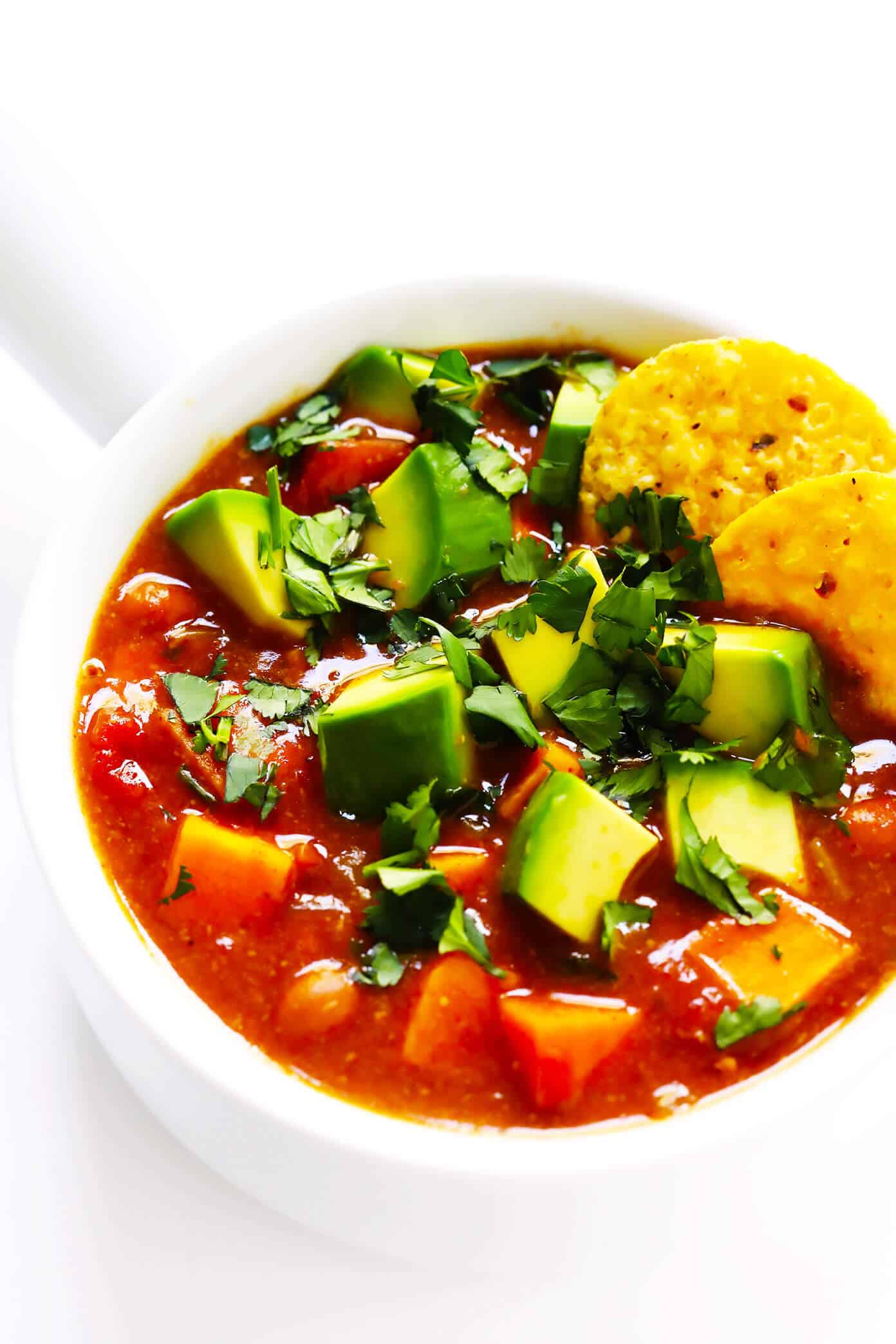 This sweet potato enchilada soup is easy to make, full of rich cheesy enchilada flavors, and SO cozy and comforting. Load this vegetarian chili up with avocado, cilantro, tortilla chips, or any of your favorite toppings and enjoy! | gimmesomeoven.com #sweetpotato #soup #chili #enchilada #taco #cheesy #stew #crockpot #dinner #healthy #freezermeal #vegetarian #vegan #glutenfree Sweet Potato Chili Recipe