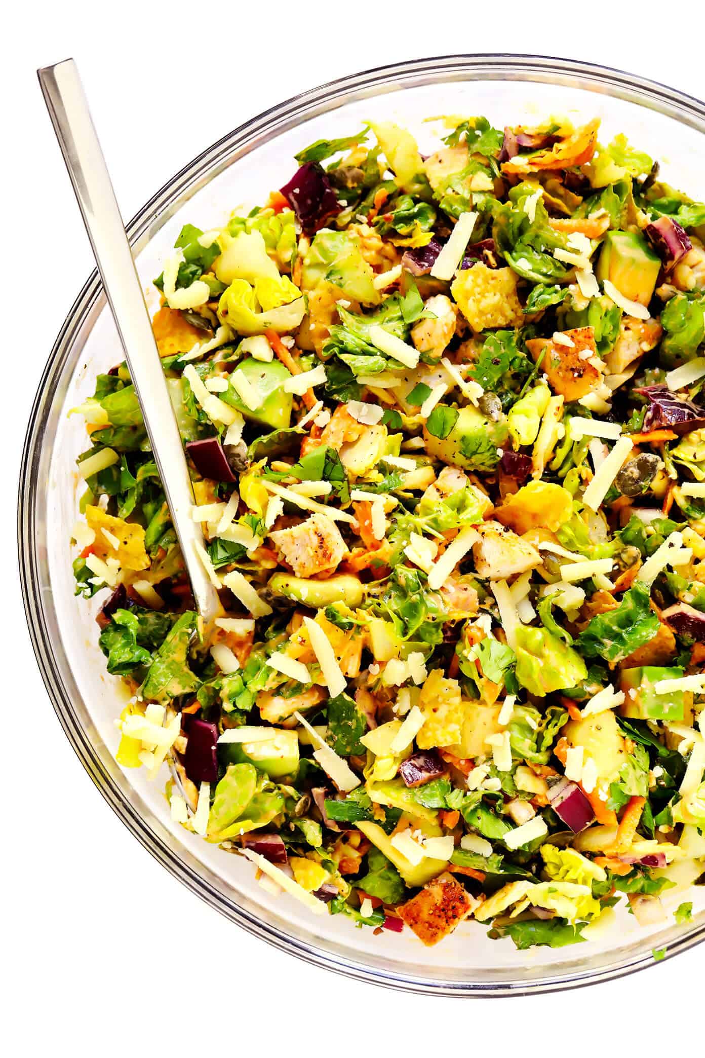This chipotle cheddar chopped salad recipe is full of the most delicious mix of crunchy greens, sharp cheddar cheese, zesty chicken, fresh cilantro, creamy avocado, and a creamy chipotle honey lime dressing. | gimmesomeoven.com #salad #chipotle #healthy #chicken #avocado #glutenfree #dinner #mexican #texmex Chipotle Chicken Chopped Salad in Mixing Bowl