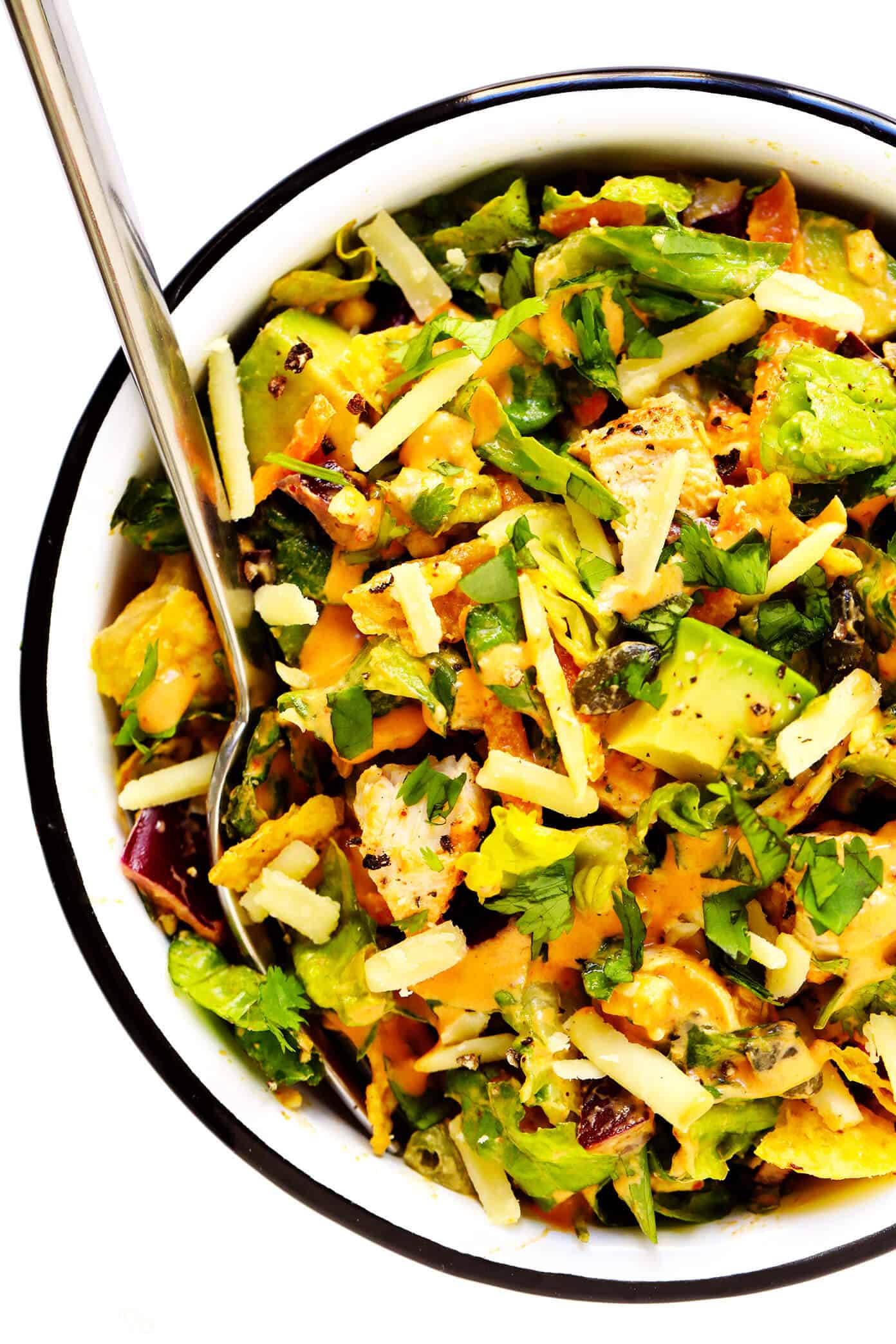This chipotle cheddar chopped salad recipe is full of the most delicious mix of crunchy greens, sharp cheddar cheese, zesty chicken, fresh cilantro, creamy avocado, and a creamy chipotle honey lime dressing. | gimmesomeoven.com #salad #chipotle #healthy #chicken #avocado #glutenfree #dinner #mexican #texmex Chopped Salad with Chipotle Dressing Mixed In