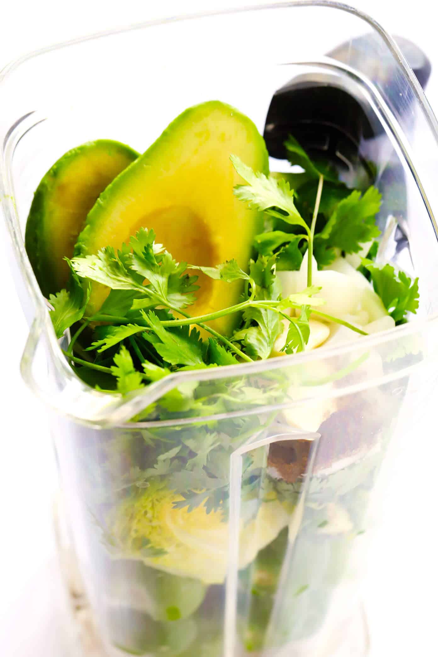 This fresh ("cruda") salsa verde recipe is easy to make in 5 minutes with raw tomatillos and avocado, and tastes refreshingly sweet, light and delicious! Serve with tortilla chips or fries, drizzle on burgers or kabobs, or whatever sounds good! | gimmesomeoven.com #salsa #verde #tomatillo #mexican #raw #glutenfree #vegan #vegetarian #healthy #sauce Ingredients for Salsa Verde Crudo in a blender