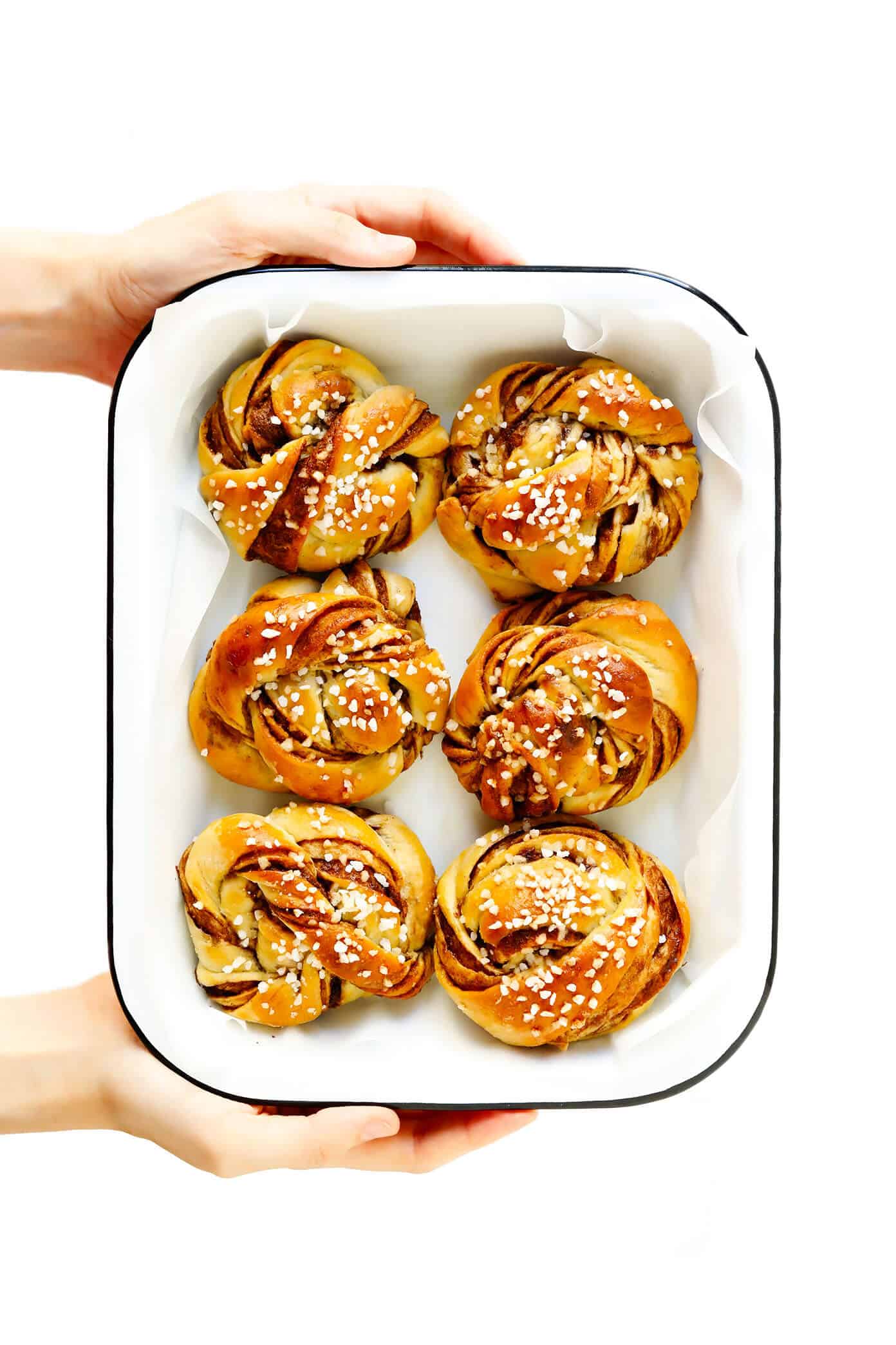 This traditional Swedish kanelbullar (cinnamon buns) recipe is made with a perfectly soft and chewy cardamom dough, a buttery cinnamon-sugar filling, and twisted into cute little knots. Top these rolls with crunchy sweet pearl sugar or any type of sugar that you have on hand! | gimmesomeoven.com #swedish #cinnamon #buns #rolls #breakfast #brunch #sweet #vegetarian #vegan Kanelbullar Recipe