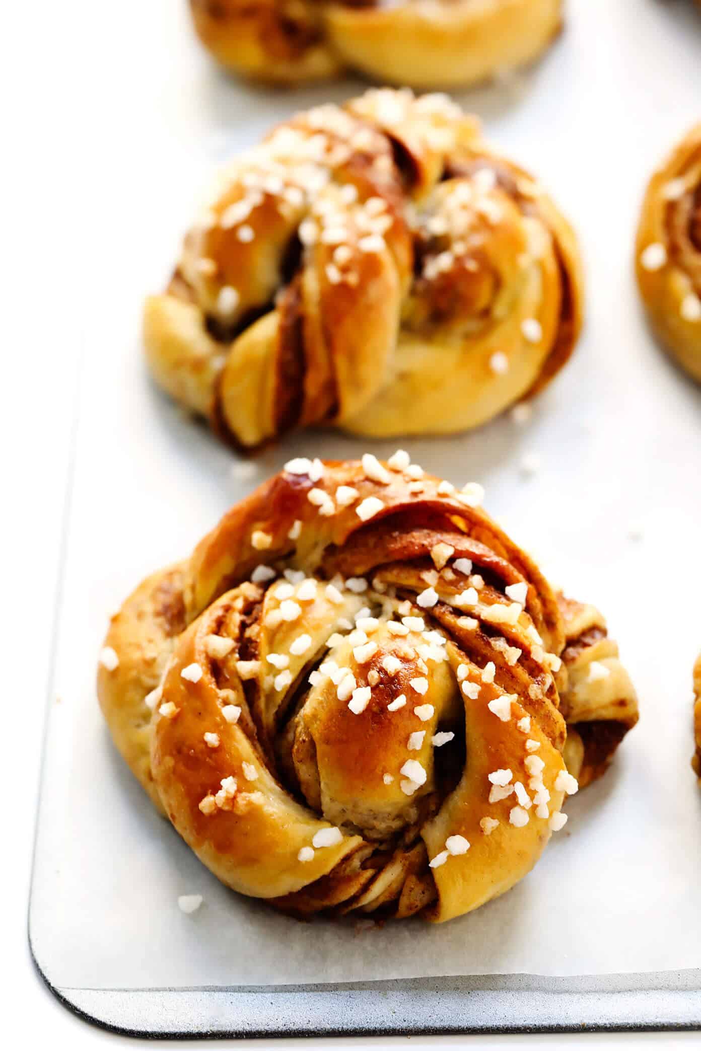 This traditional Swedish kanelbullar (cinnamon buns) recipe is made with a perfectly soft and chewy cardamom dough, a buttery cinnamon-sugar filling, and twisted into cute little knots. Top these rolls with crunchy sweet pearl sugar or any type of sugar that you have on hand! | gimmesomeoven.com #swedish #cinnamon #buns #rolls #breakfast #brunch #sweet #vegetarian #vegan The Best Kanelbullar (Swedish Cinnamon Rolls)