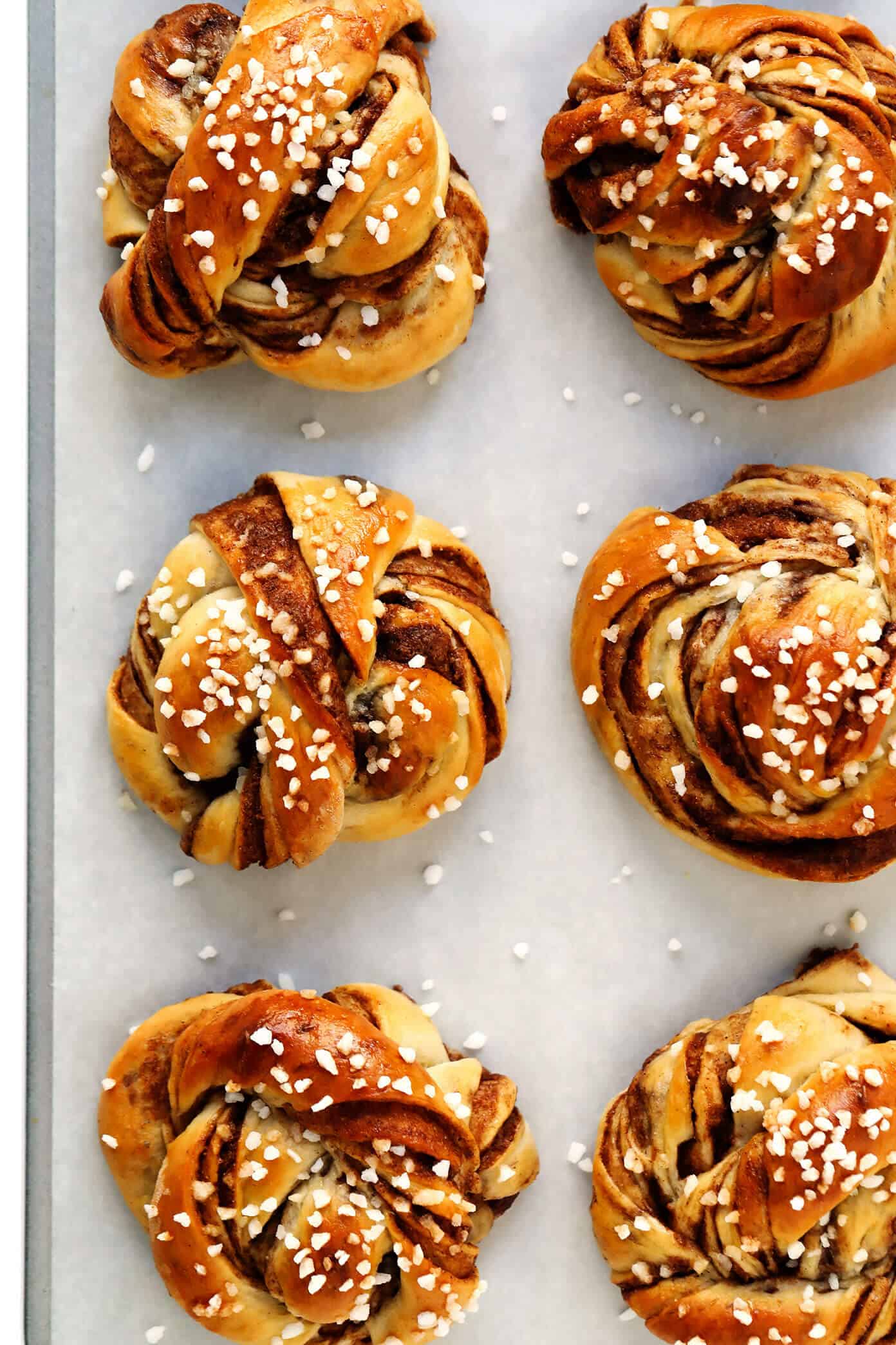 This traditional Swedish kanelbullar (cinnamon buns) recipe is made with a perfectly soft and chewy cardamom dough, a buttery cinnamon-sugar filling, and twisted into cute little knots. Top these rolls with crunchy sweet pearl sugar or any type of sugar that you have on hand! | gimmesomeoven.com #swedish #cinnamon #buns #rolls #breakfast #brunch #sweet #vegetarian #vegan Swedish Cinnamon Roll Recipe (with Pearl Sugar)
