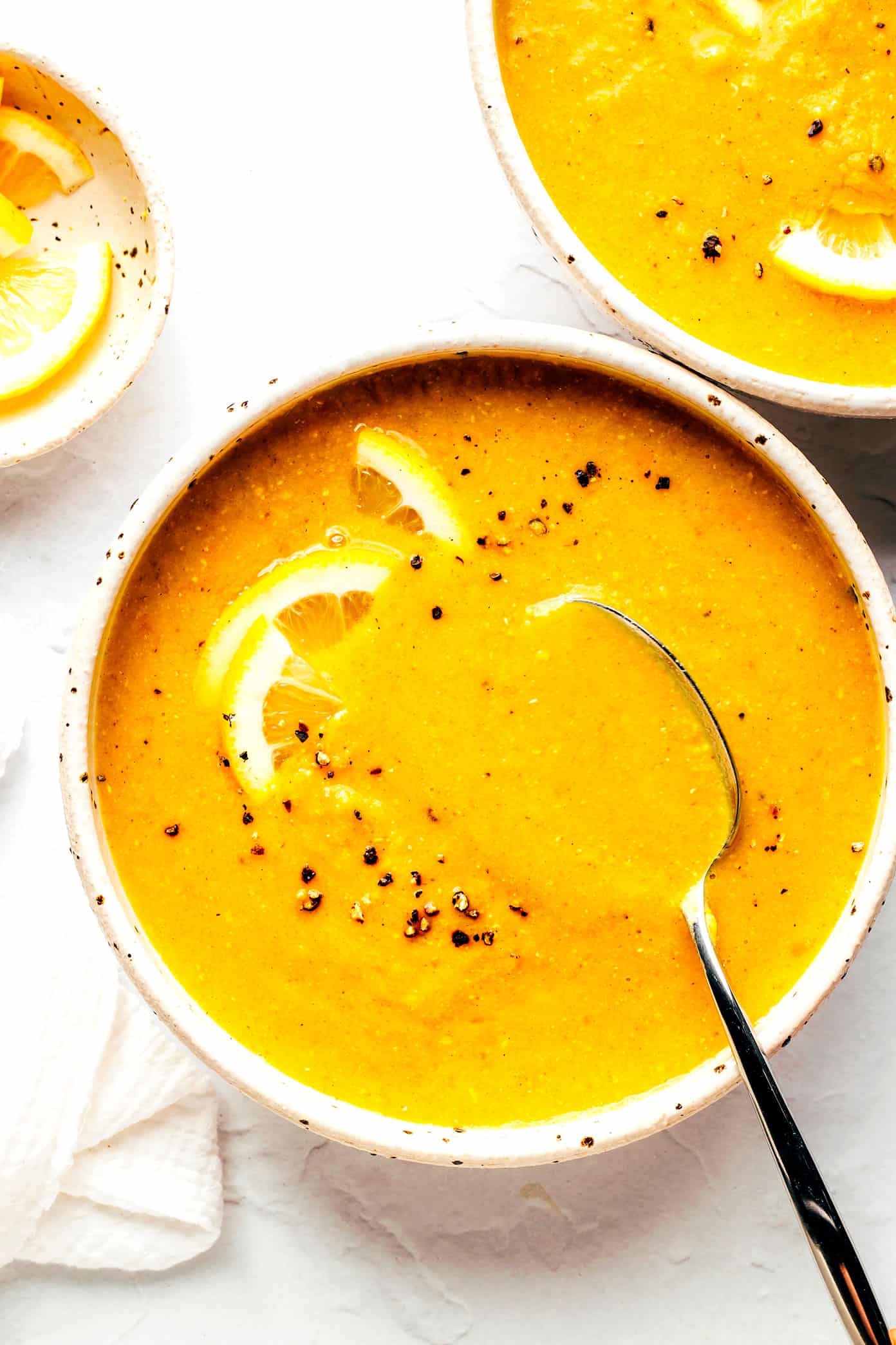 This Lemony Lentil Soup recipe is full of hearty red lentils and veggies, zesty seasonings, and a bright squeeze of lemon. Naturally gluten-free, vegetarian and vegan, easy to make in the Instant Pot, Crock-Pot or on the stovetop, and always so delicious. Such a great healthy and easy dinner recipe! | gimmesomeoven.com Lemony Red Lentil Soup in Bowls