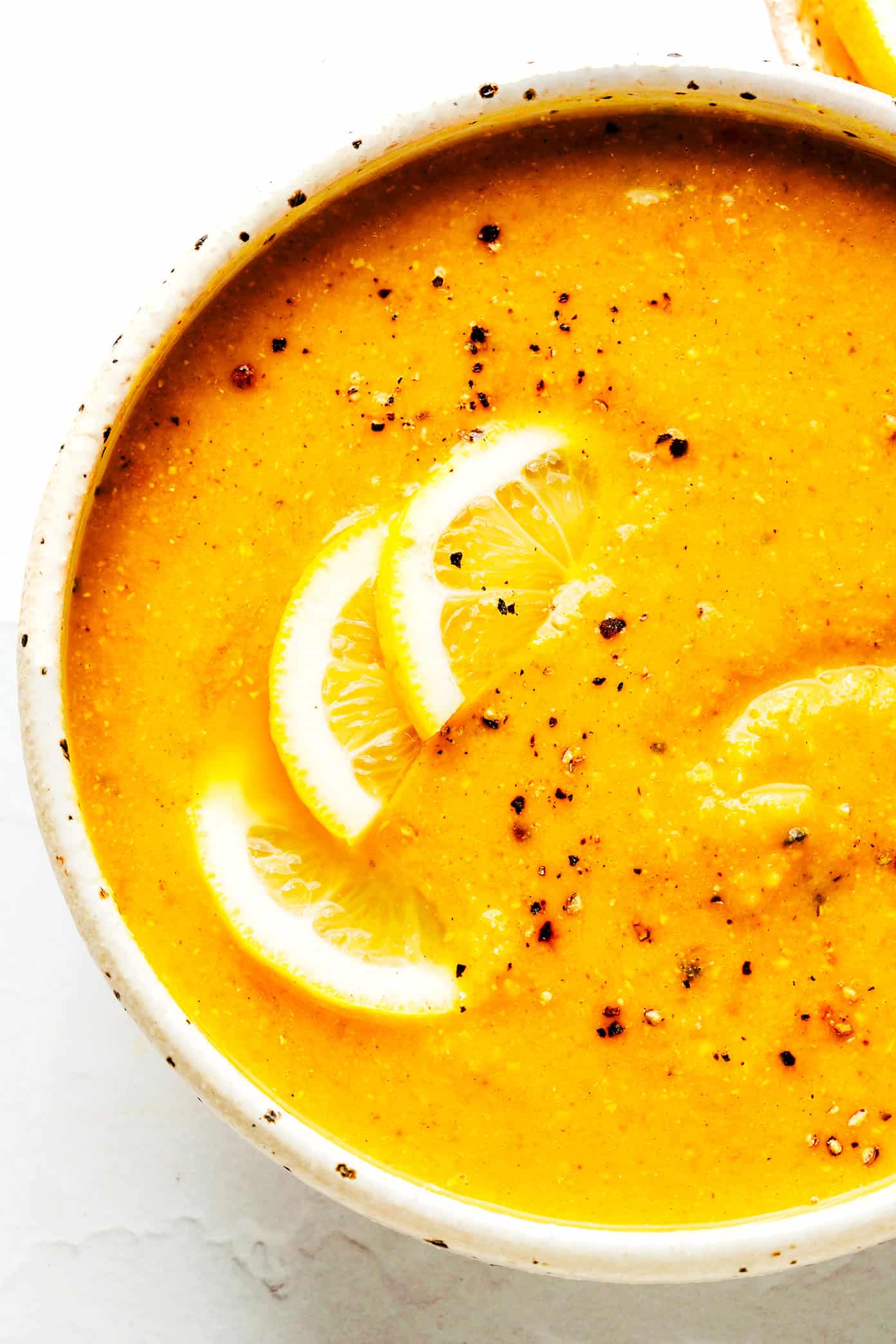 This Lemony Lentil Soup recipe is full of hearty red lentils and veggies, zesty seasonings, and a bright squeeze of lemon. Naturally gluten-free, vegetarian and vegan, easy to make in the Instant Pot, Crock-Pot or on the stovetop, and always so delicious. Such a great healthy and easy dinner recipe! | gimmesomeoven.com Closeup of Lemony Lentil Soup in Bowl