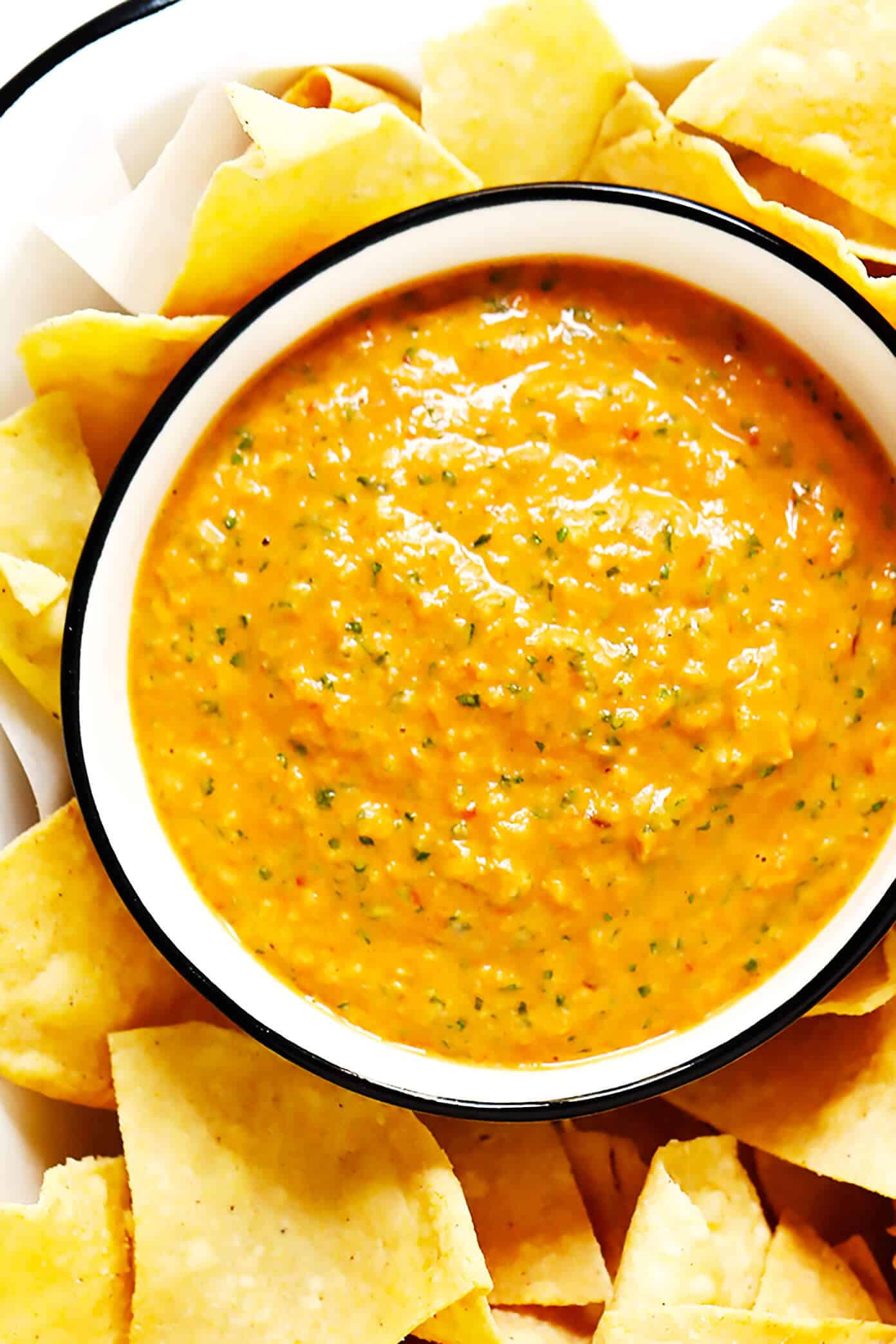 This creamy Peanut Chipotle Salsa recipe is made with a classic tomato, onion, garlic and cilantro base, then layered with sweet peanut butter and smoky chipotle pepper. It's easy to make in 10 minutes, naturally gluten-free and vegan, and crazy delicious. And perfect for serving as a dip, sauce, spread or whatever sounds good! | gimmesomeoven.com #salsa #tomato #peanut #mexican #chipotle #dip #sauce #spread #glutenfree #vegan #healthy #chips Chipotle Peanut Salsa in a bowl with tortilla chips