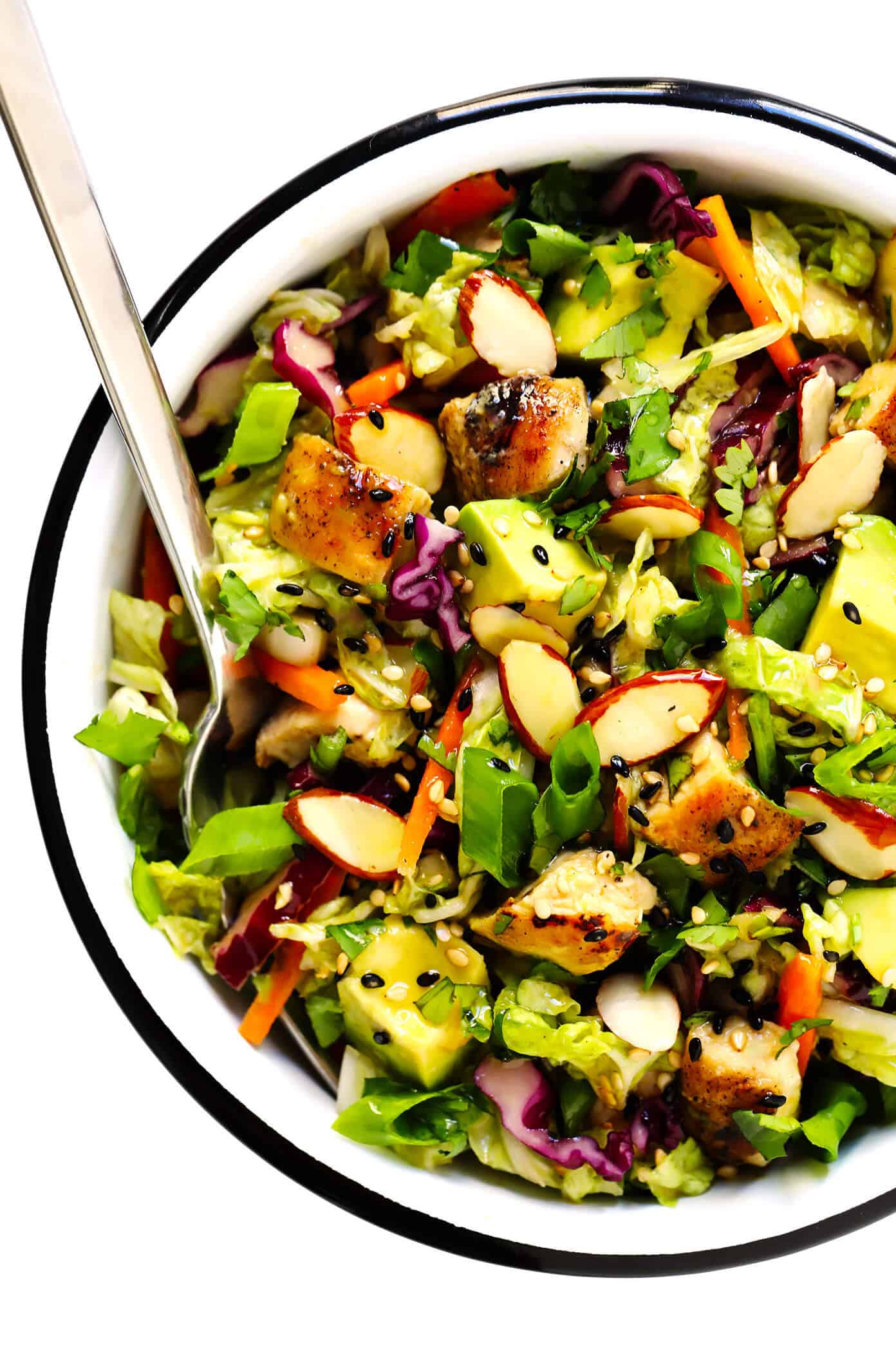 This Sesame Chicken Salad recipe is made with crisp cole slaw and carrots, zesty chicken, crunchy toasted almonds, creamy avocado, lots of fresh cilantro and a quick sesame soy vinaigrette. It's a simple salad recipe that always hits the spot! | gimmesomeoven.com #salad #sesame #asian #almond #avocado #chicken #vinaigrette #dressing #mealprep #healthy #glutenfree Green Salad with Chicken, Avocado and Sesame Vinaigrette