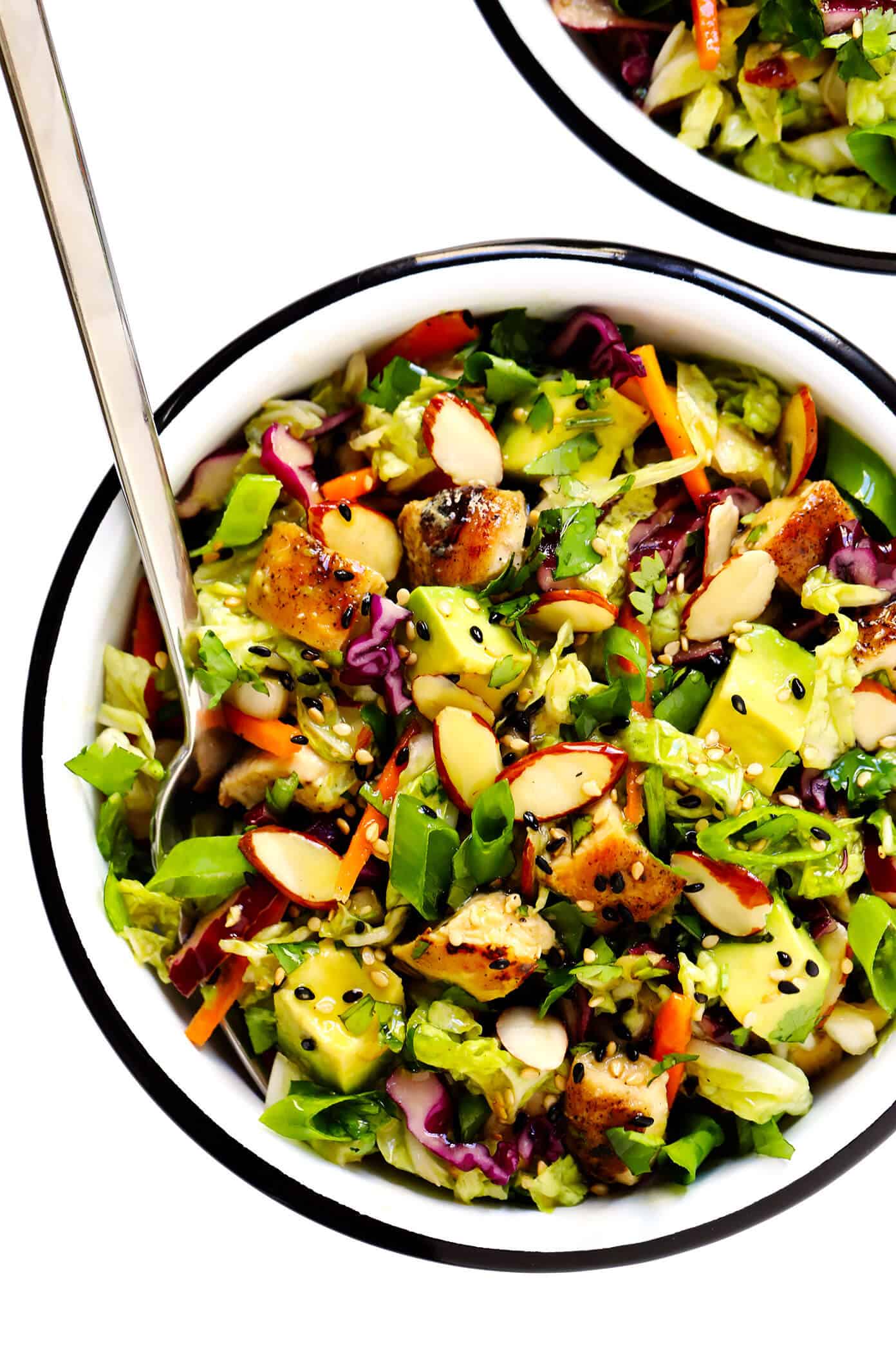 This Sesame Chicken Salad recipe is made with crisp cole slaw and carrots, zesty chicken, crunchy toasted almonds, creamy avocado, lots of fresh cilantro and a quick sesame soy vinaigrette. It's a simple salad recipe that always hits the spot! | gimmesomeoven.com #salad #sesame #asian #almond #avocado #chicken #vinaigrette #dressing #mealprep #healthy #glutenfree Sesame Chicken Salad Recipe with Almonds, Avocado and Cilantro