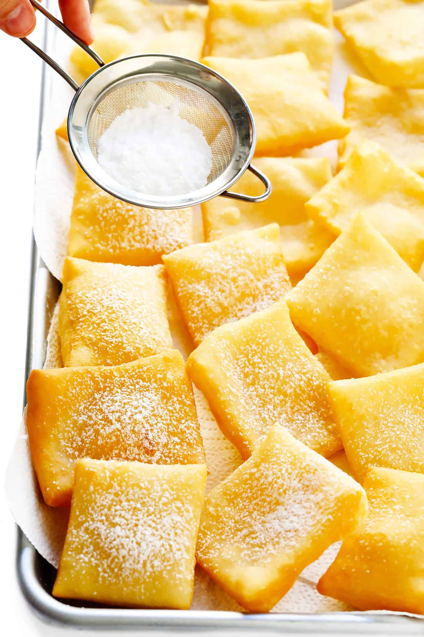 This restaurant-style sopapilla recipe is easy to make at home with pantry ingredients and always a crowd fave. Sprinkle your sopapillas in powdered sugar or dip in cinnamon-sugar -- up to you! | gimmesomeoven.com #sopapillas #dessert #mexican #texmex #donut #frybread #sweet How To Make Sopapillas
