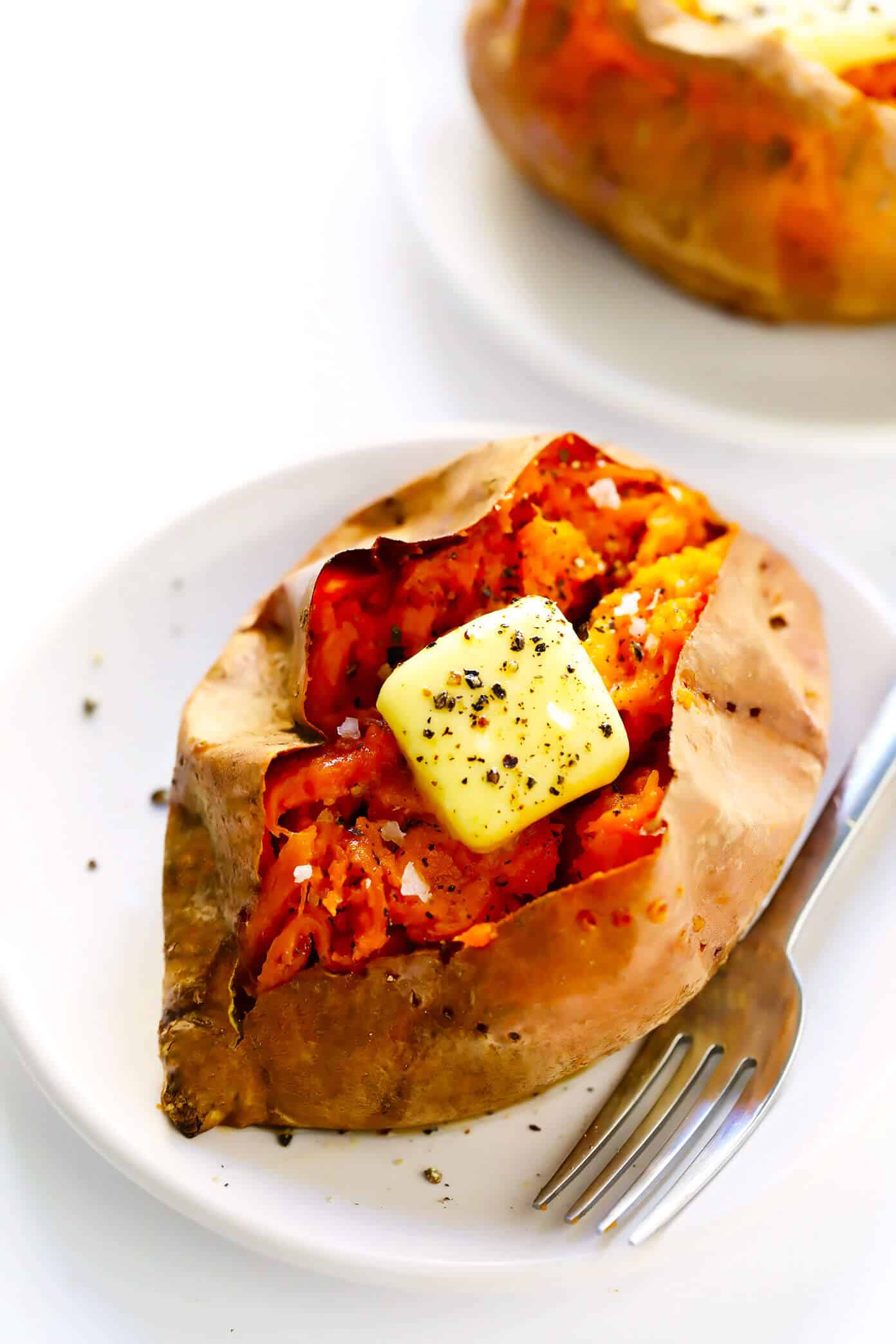 My favorite method for how to bake sweet potatoes in the oven that are perfectly crispy on the outside and soft on the inside. Plus, lots of ideas for loaded potato toppings you can add on too! | gimmesomeoven.com #sweetpotato #healthy #glutenfree #vegan #vegetarian #dinner #side Baked Sweet Potato with Fork