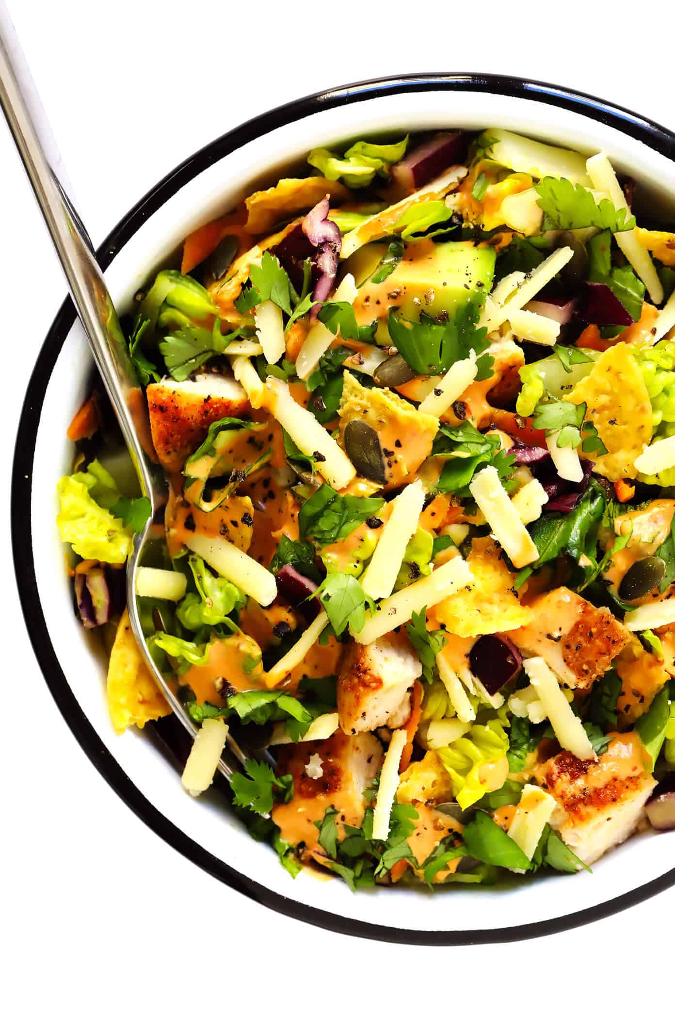 This chipotle cheddar chopped salad recipe is full of the most delicious mix of crunchy greens, sharp cheddar cheese, zesty chicken, fresh cilantro, creamy avocado, and a creamy chipotle honey lime dressing. | gimmesomeoven.com #salad #chipotle #healthy #chicken #avocado #glutenfree #dinner #mexican #texmex Chipotle Cheddar Chopped Salad Recipe