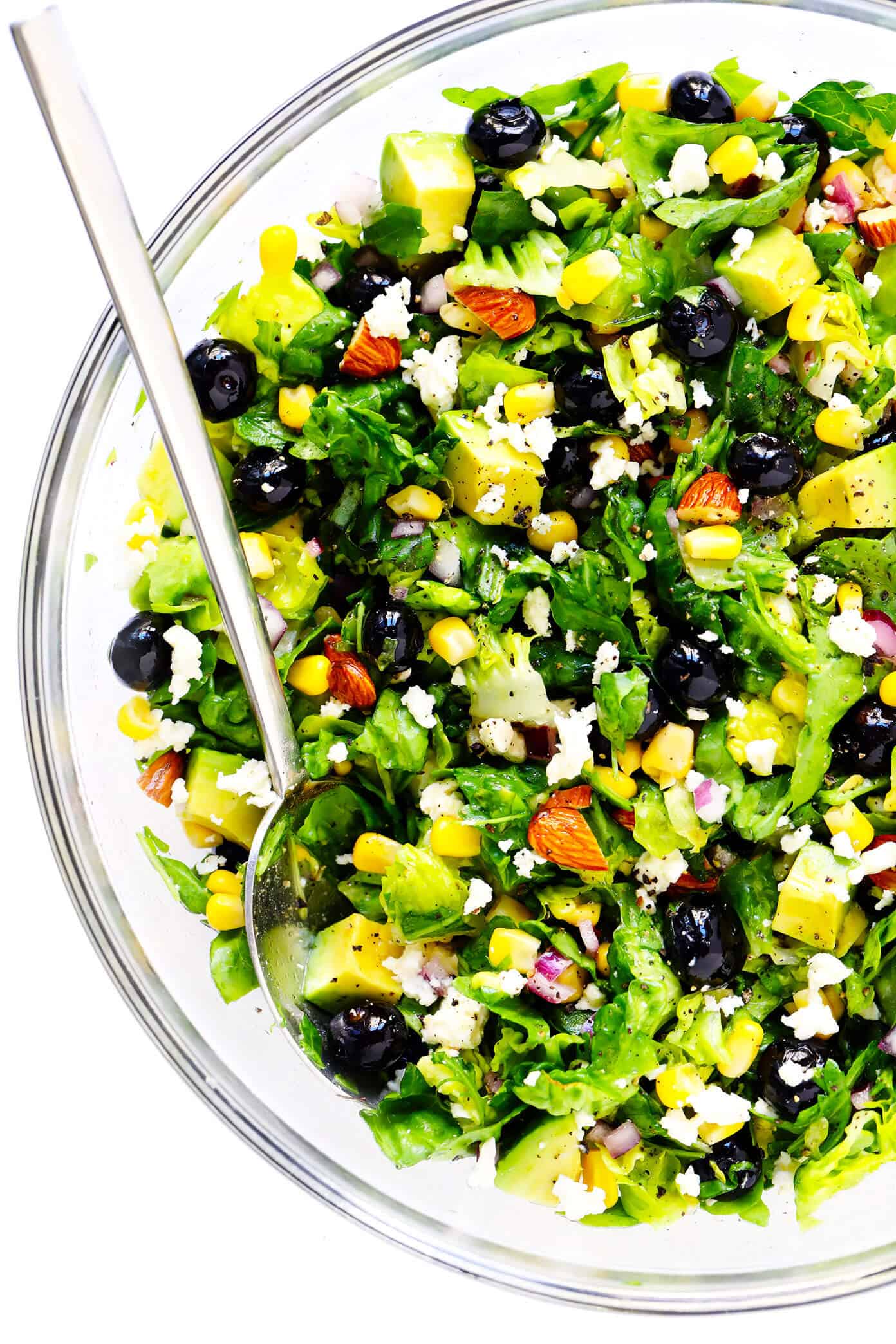 This Blueberry, Corn & Avocado Chopped Salad recipe is tossed with lots of fresh basil, toasted almonds, crumbled feta, red onions, and an easy lemon dressing. The perfect salad for summertime! | gimmesomeoven.com #salad #blueberry #corn #avocado #chopped #glutenfree #healthy #dinner #vegetarian #summer Big bowl of blueberry, corn and avocado salad