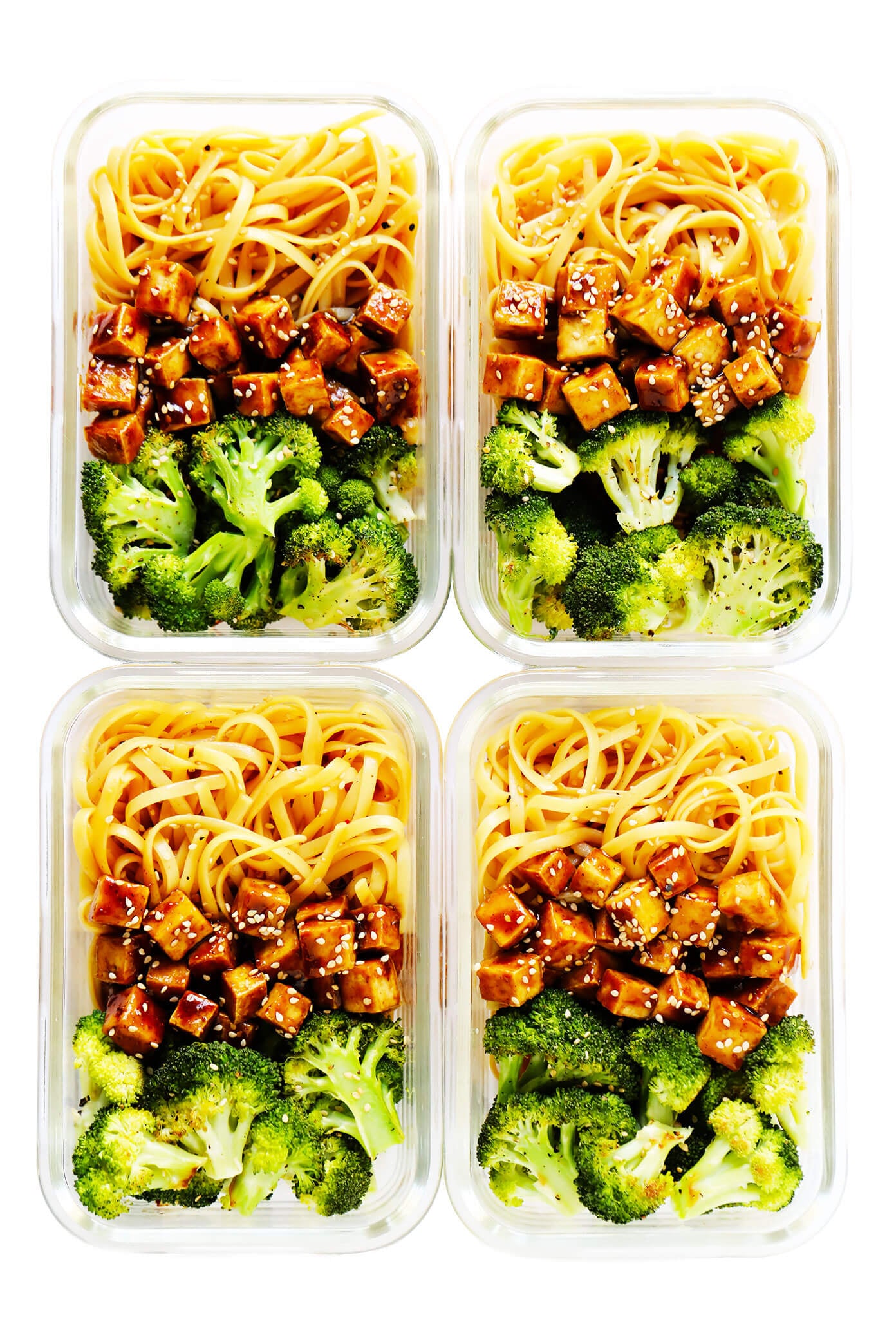Crispy tofu is tossed with a flavor-packed sweet and savory sauce (made with hoisin, rice vinegar and five spice) and served over my favorite sesame noodles. It's perfect for a weeknight dinner or easy meal prep! (Feel free to use chicken, pork, beef, shrimp, salmon or tempeh in place of the tofu if you prefer.) | gimmesomeoven.com #tofu #noodles #sesame #asian #broccoli #dinner #healthy #vegan #vegetarian #healthy #mealprep #bowl #stirfry Crispy Tofu Sesame Noodle Bowls in Meal Prep Containers