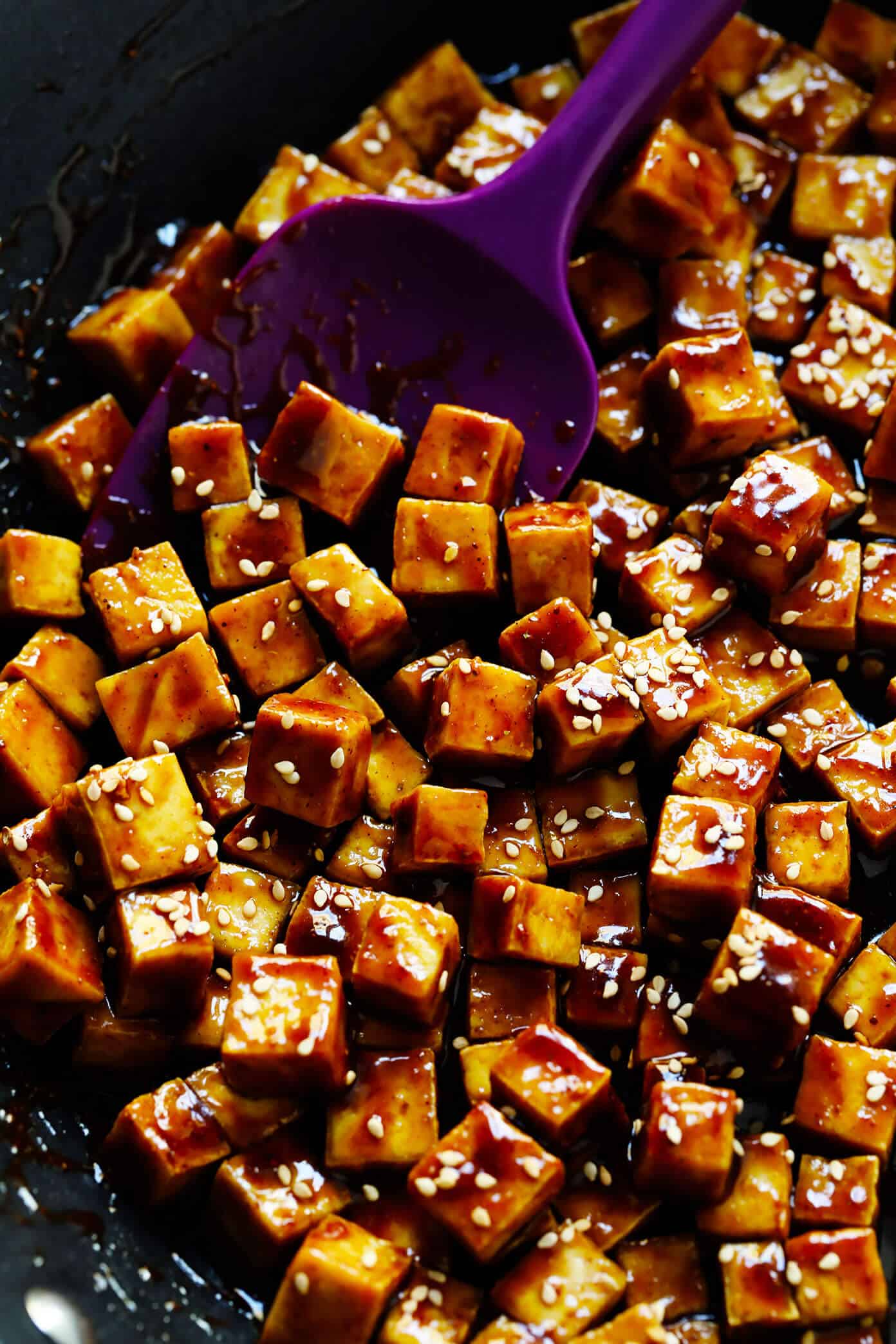 Crispy tofu is tossed with a flavor-packed sweet and savory sauce (made with hoisin, rice vinegar and five spice) and served over my favorite sesame noodles. It's perfect for a weeknight dinner or easy meal prep! (Feel free to use chicken, pork, beef, shrimp, salmon or tempeh in place of the tofu if you prefer.) | gimmesomeoven.com #tofu #noodles #sesame #asian #broccoli #dinner #healthy #vegan #vegetarian #healthy #mealprep #bowl #stirfry Crispy Tofu in a Sauté Pan with Five Spice Hoisin Sauce