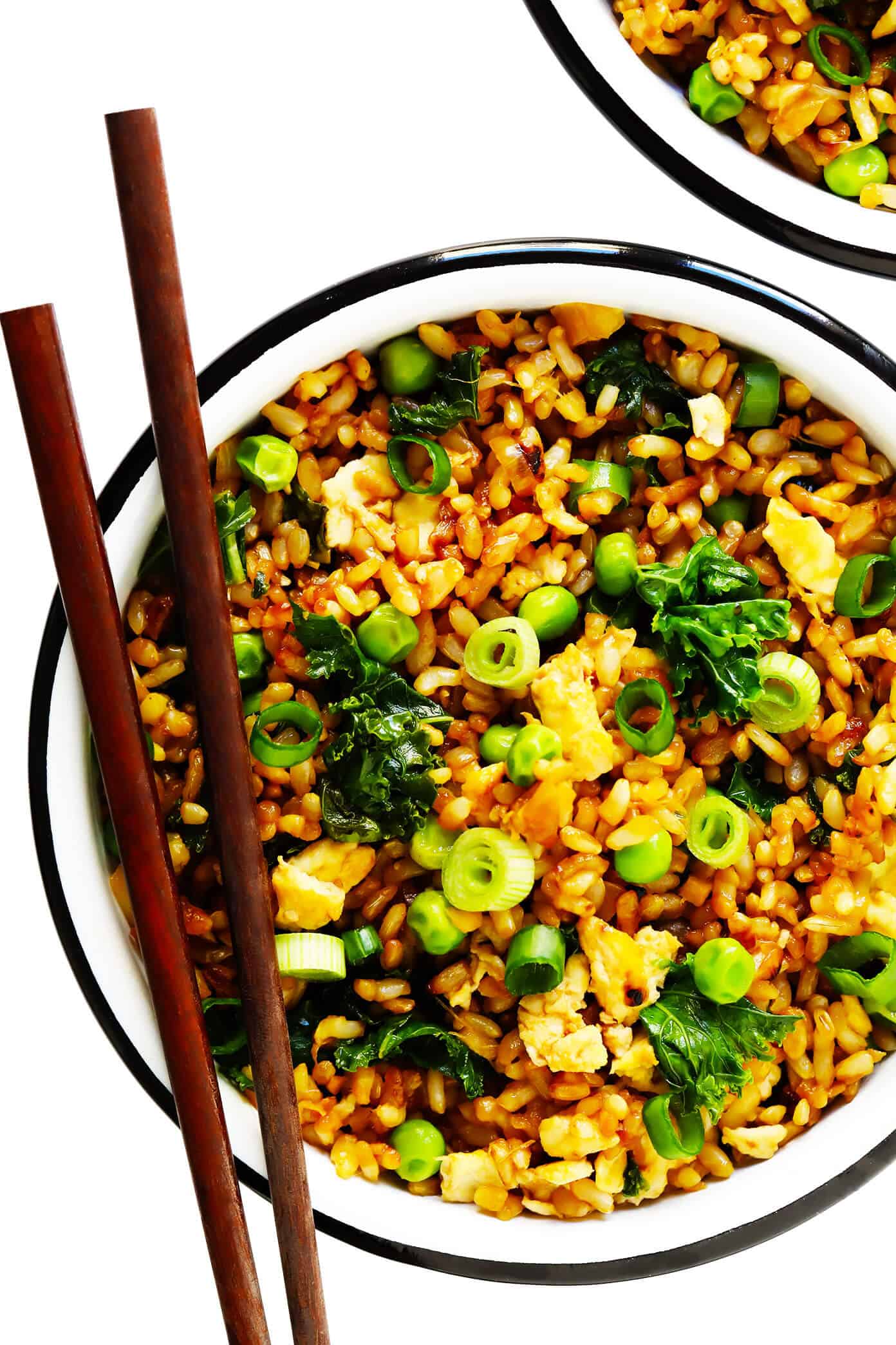 This ginger kale fried rice recipe is quick and easy to make, full of great garlicky ginger flavor, and pan-fried until the rice is extra-crispy! Feel free to add in extra protein (chicken, shrimp, tofu, etc) or extra veggies if you would like. | gimmesomeoven.com #rice #friedrice #dinner #healthy #vegetarian #glutenfree #vegan Ginger Kale Fried Rice
