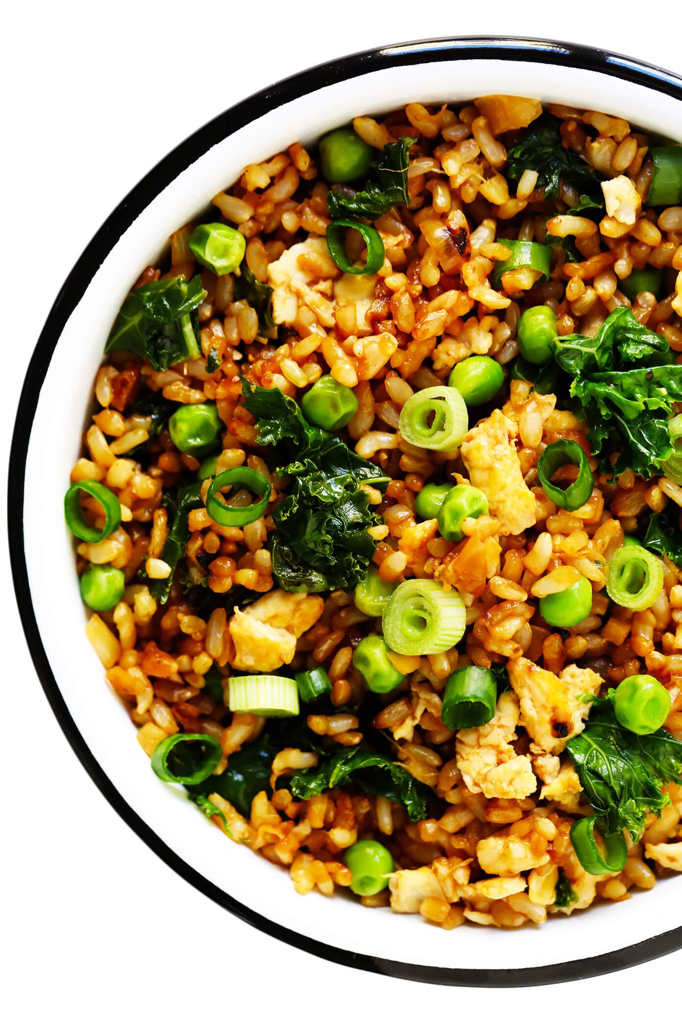 This ginger kale fried rice recipe is quick and easy to make, full of great garlicky ginger flavor, and pan-fried until the rice is extra-crispy! Feel free to add in extra protein (chicken, shrimp, tofu, etc) or extra veggies if you would like. | gimmesomeoven.com #rice #friedrice #dinner #healthy #vegetarian #glutenfree #vegan Ginger Kale Fried Rice In Bowl