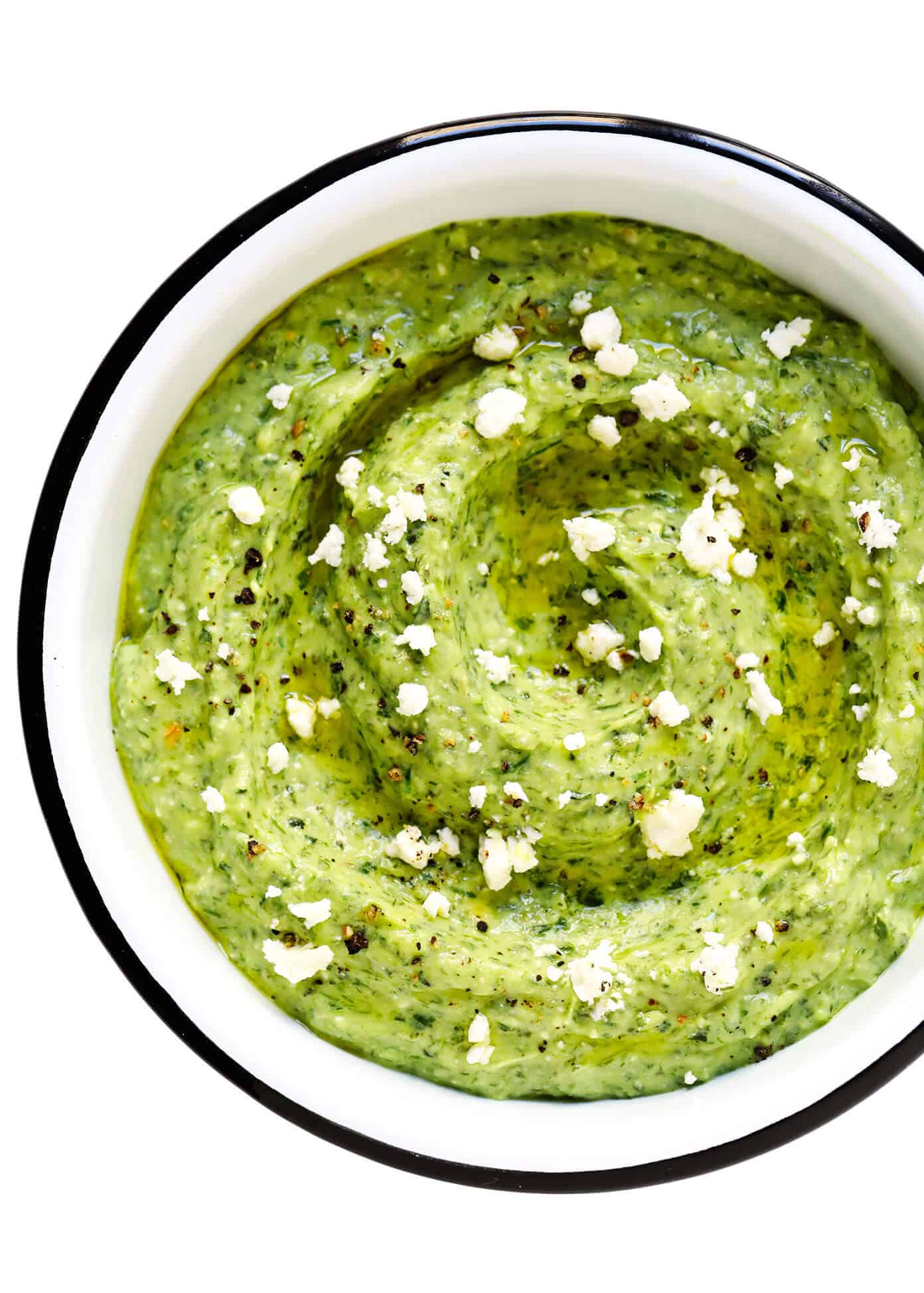 This Green Goddess Feta Dip recipe is packed with tons of fresh herbs (basil, mint, dill), creamy avocado, and lots of tangy lemon and feta. Serve it up with crusty bread, veggies, crackers or any of your favorite dippers! | gimmesomeoven.com #greengoddess #avocado #dip #spread #summer #feta #cheese #vegetarian #glutenfree #appetizer #mediterranean Green Goddess Dip with Crumbled Feta On Top
