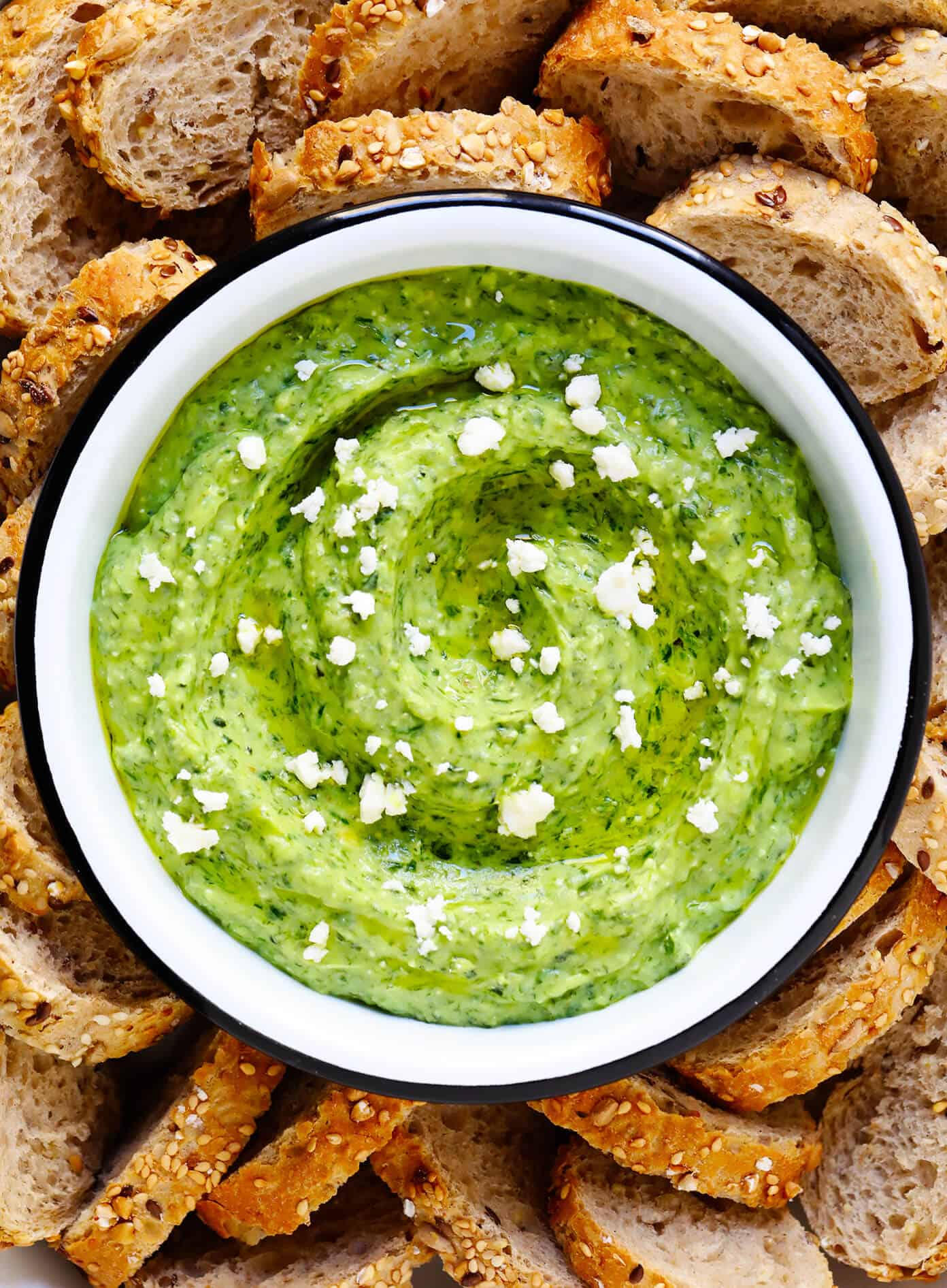 This Green Goddess Feta Dip recipe is packed with tons of fresh herbs (basil, mint, dill), creamy avocado, and lots of tangy lemon and feta. Serve it up with crusty bread, veggies, crackers or any of your favorite dippers! | gimmesomeoven.com #greengoddess #avocado #dip #spread #summer #feta #cheese #vegetarian #glutenfree #appetizer #mediterranean Greek Goddess Feta Dip with Crusty Bread