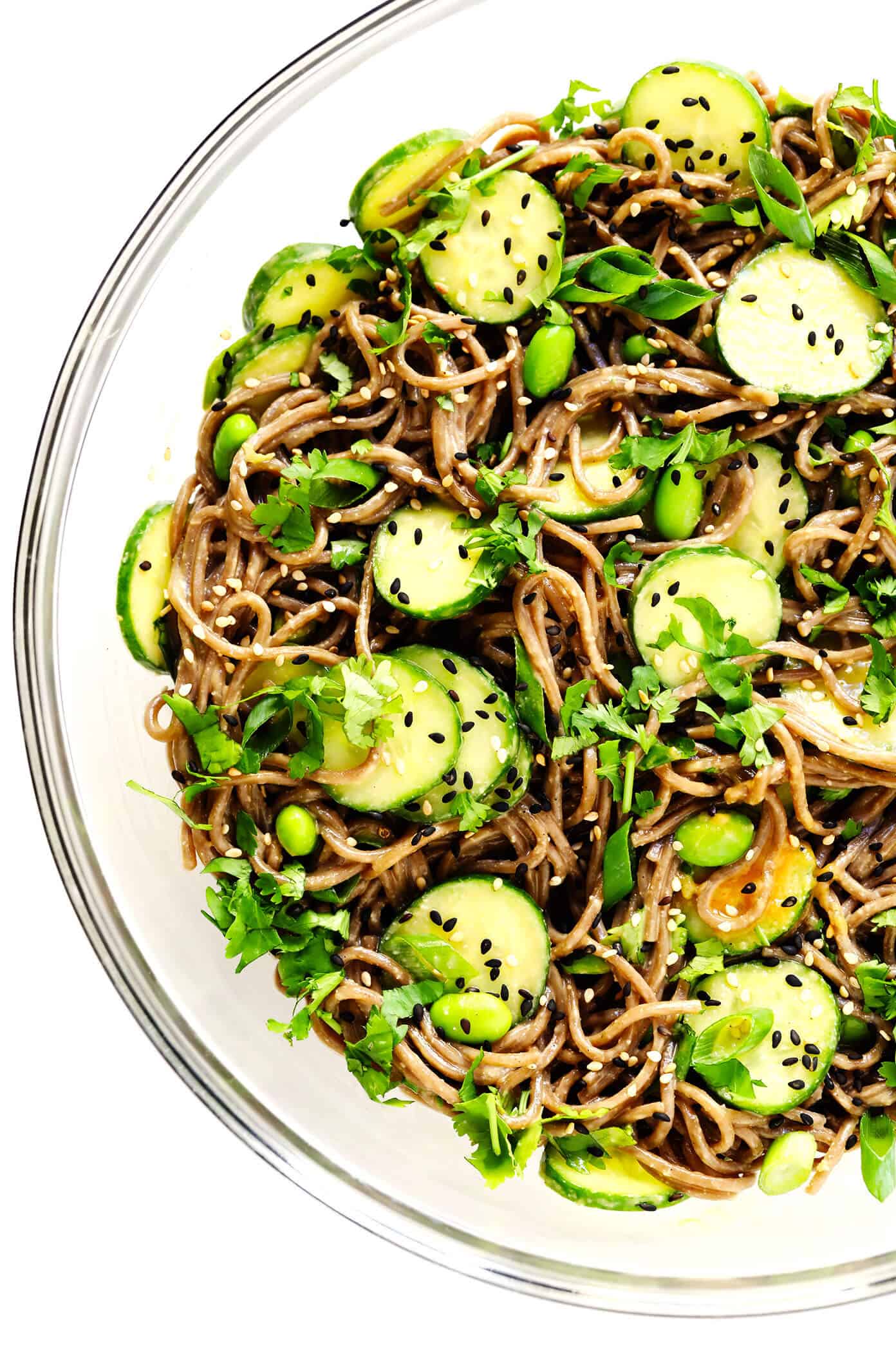 These chilled peanut soba noodles are tossed with cucumber, edamame, fresh herbs and an irresistible peanut sauce...and ready to go in just 20 minutes! Feel free to add extra veggies or a protein (salmon, shrimp, chicken, etc) if you would like. | gimmesomeoven.com #soba #noodles #pasta #salad #healthy #mealprep #glutenfree #vegetarian #vegan #dinner Chilled Peanut Noodles In Bowl