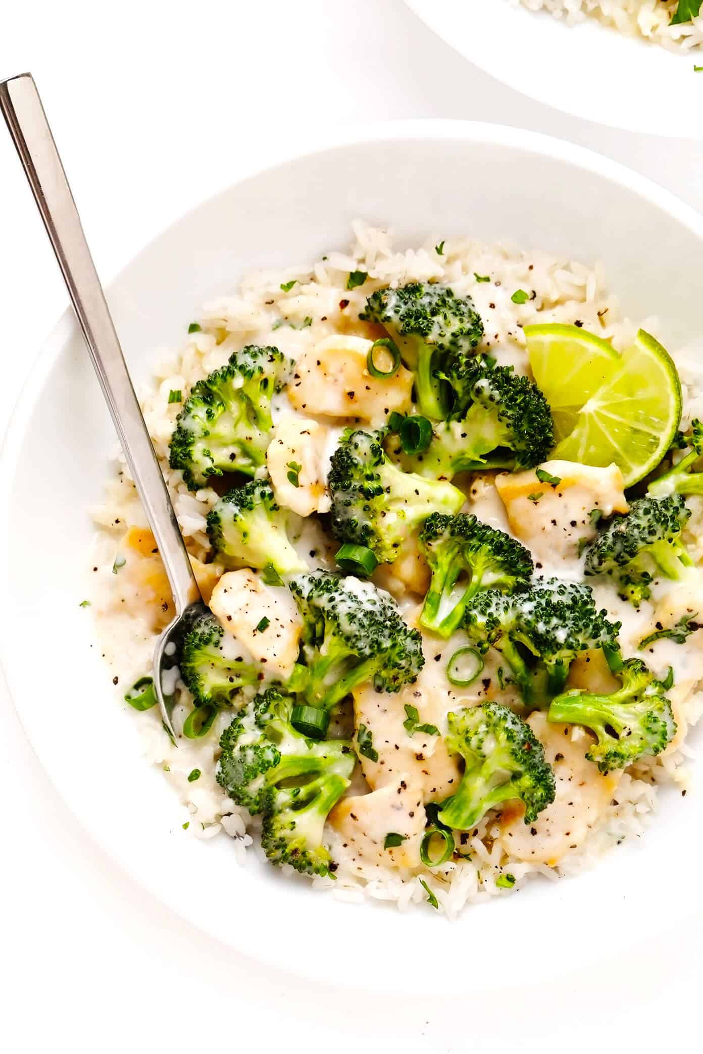 This Coconut Lime Chicken and Broccoli stir-fry recipe is easy to make in 30 minutes and simmered in a tangy coconut sauce seasoned with ginger, lemongrass and garlic. Serve over rice or noodles for a quick dinner and enjoy! | gimmesomeoven.com #chicken #broccoli #thai #coconut #lime #sauce #dinner #healthy #stirfry #rice #noodles #glutenfree Coconut Lime Broccoli Chicken with Rice In Serving Bowl