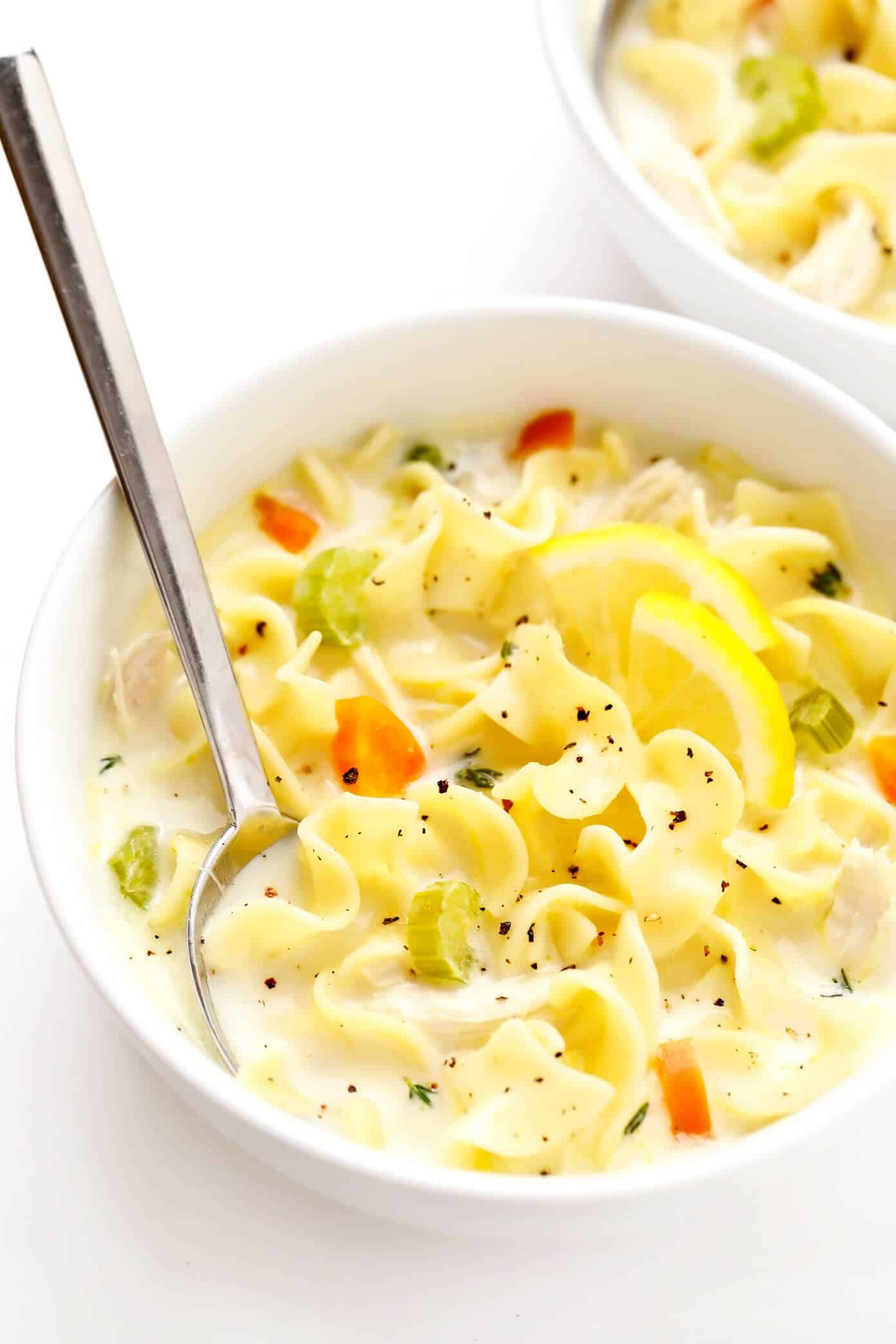 This creamy lemon chicken noodle soup is made with all of the classic ingredients we all love and a cozy creamy broth that's brightened up with lots of fresh lemon juice and thyme. So comforting and delicious! | gimmesomeoven.com #chicken #noodle #soup #creamy #lemon #dinner #winter #onepot #healthy Bowl of Lemon Chicken Noodle Soup