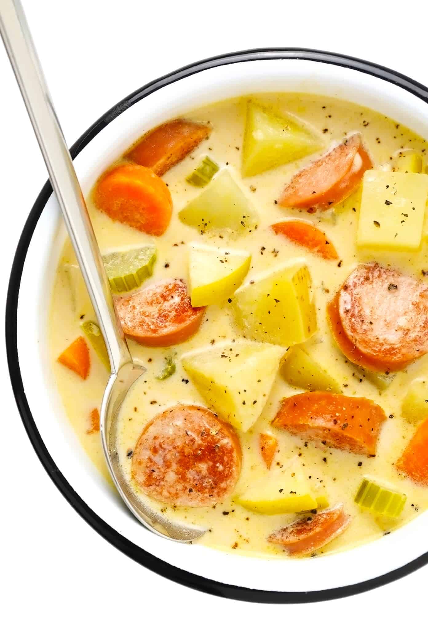 This Smoked Sausage, Apple and Potato Soup recipe is easy to make and simmered in the yummiest creamy broth made with coconut milk (or cream) and zesty Old Bay seasoning. The perfect easy dinner recipe to warm you up on a chilly night! | gimmesomeoven.com
