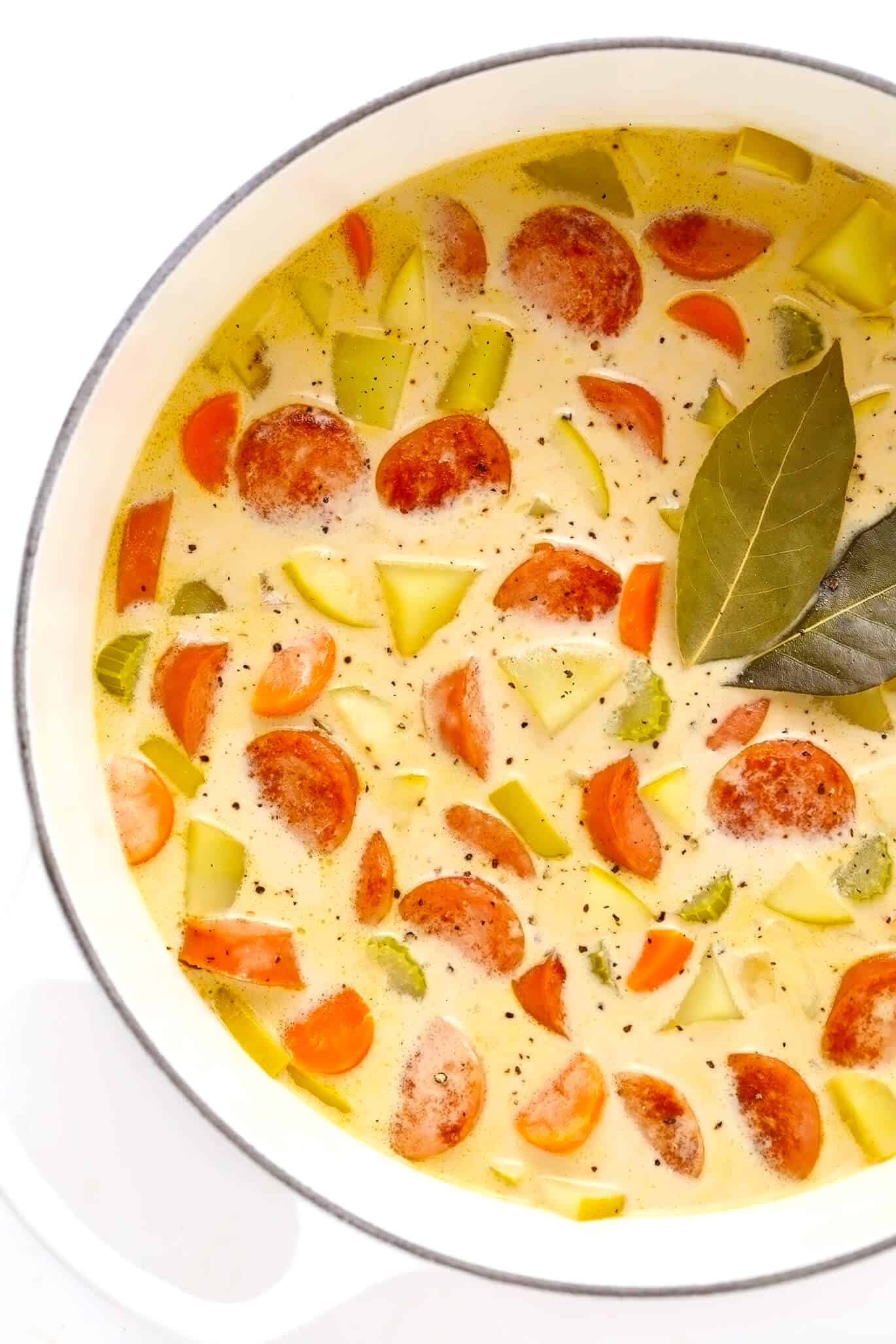 This Smoked Sausage, Apple and Potato Soup recipe is easy to make and simmered in the yummiest creamy broth made with coconut milk (or cream) and zesty Old Bay seasoning. The perfect easy dinner recipe to warm you up on a chilly night! | gimmesomeoven.com Smoked Sausage, Apple and Potato Soup recipe
