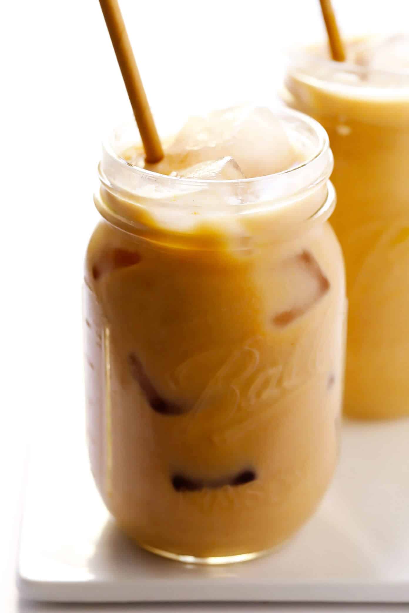 My favorite Iced Pumpkin Spice Latte recipe is made with real pumpkin puree, your choice of milk (dairy or vegan), and naturally sweetened with just a hint of maple syrup. Easy to make in 5 minutes and considerably cheaper than the coffee shop version! | gimmesomeoven.com #pumpkin #latte #coffee #drink #vegan #glutenfree #psl #iced #cold #fall #autumn #winter Iced Pumpkin Spice Lattes without Whipped Cream