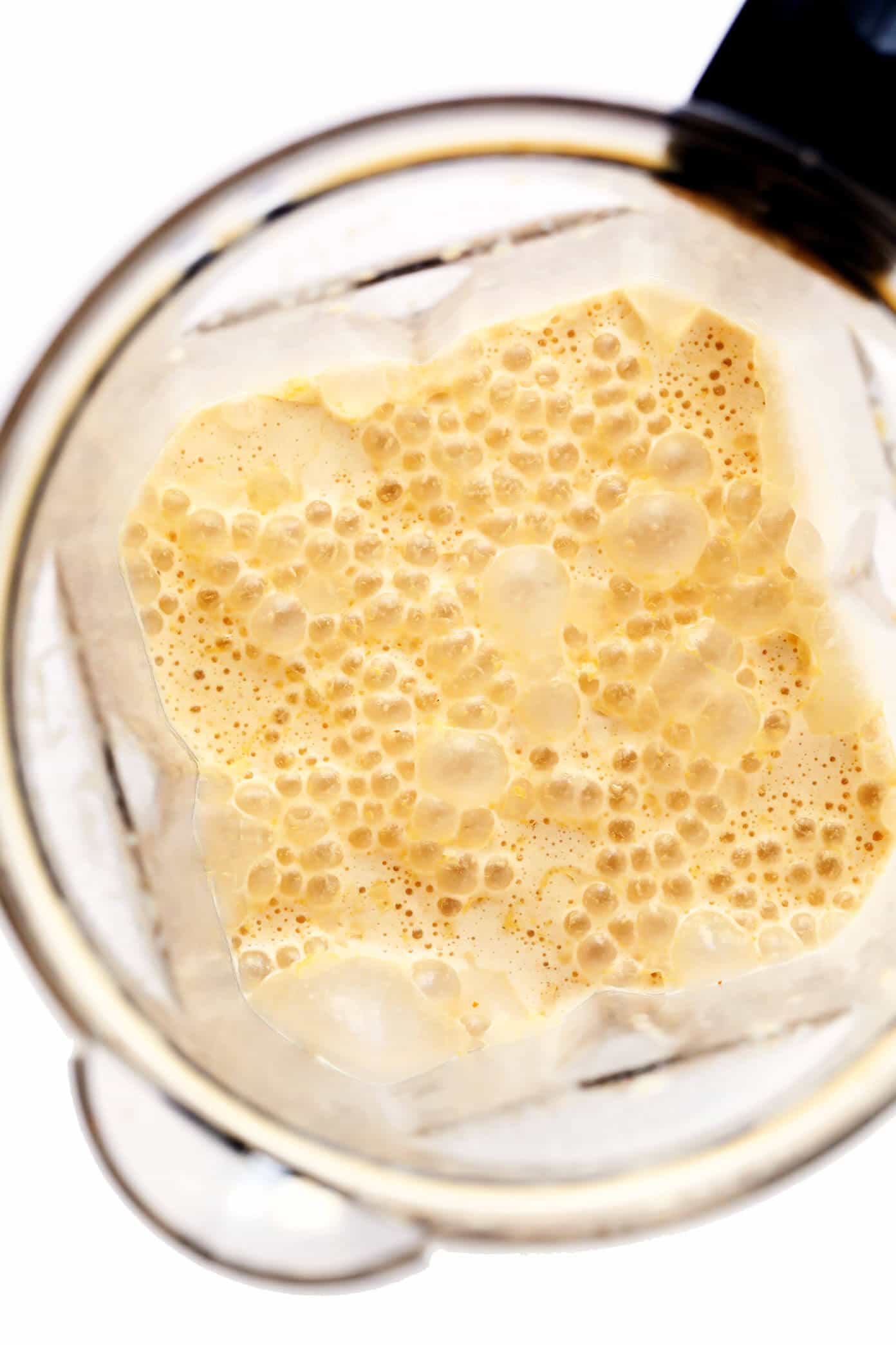 My favorite Iced Pumpkin Spice Latte recipe is made with real pumpkin puree, your choice of milk (dairy or vegan), and naturally sweetened with just a hint of maple syrup. Easy to make in 5 minutes and considerably cheaper than the coffee shop version! | gimmesomeoven.com #pumpkin #latte #coffee #drink #vegan #glutenfree #psl #iced #cold #fall #autumn #winter Blending an Iced PSL in a blender