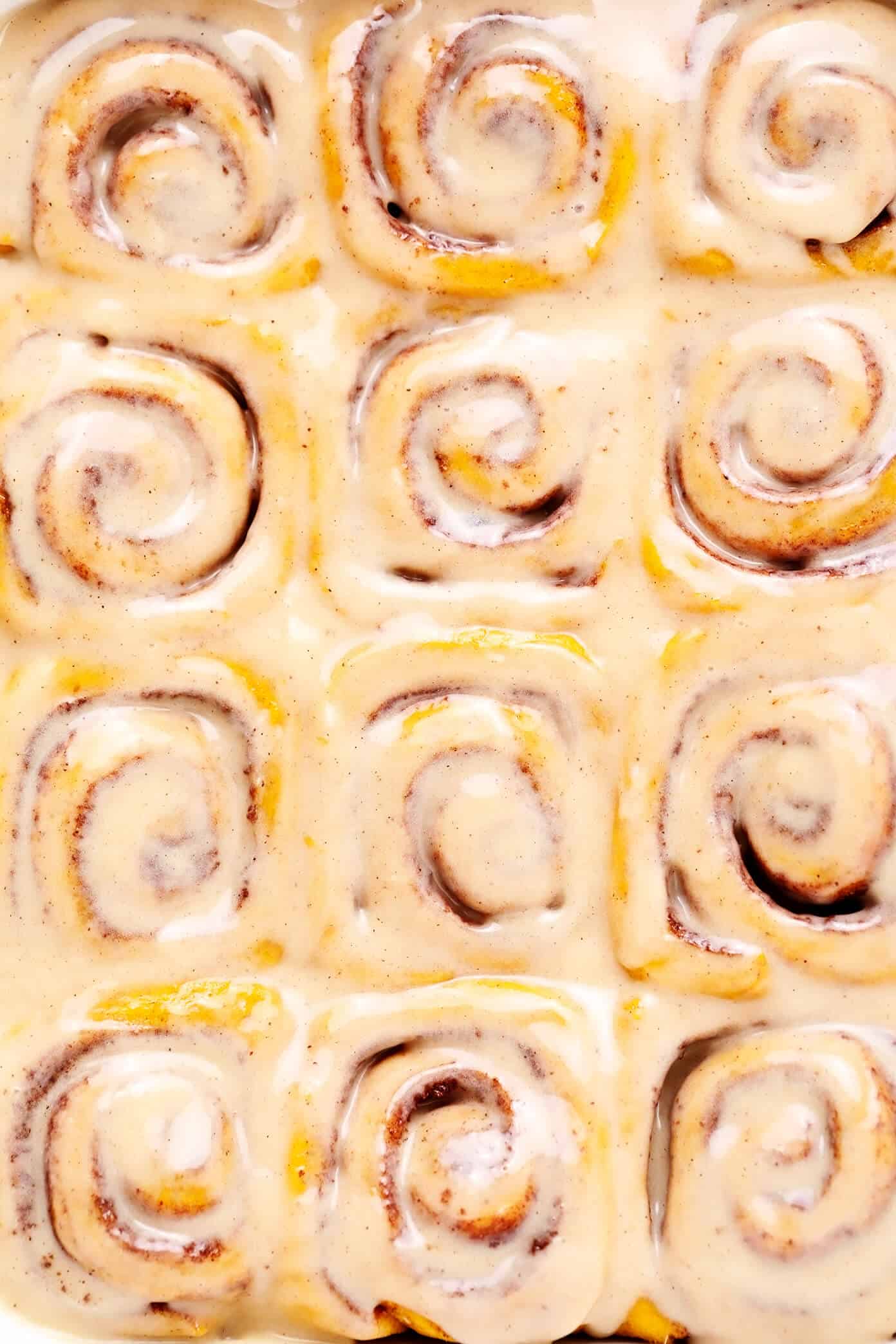 These pumpkin cinnamon rolls are perfectly delicious, soft, chewy and topped with a heavenly maple cream cheese frosting. Easy to make and ready to go in just around 1 hour! | gimmesomeoven.com #pumpkin #cinnamon #rolls #buns #breakfast #brunch #pumpkinspice #fall Pumpkin Cinnamon Rolls Closeup