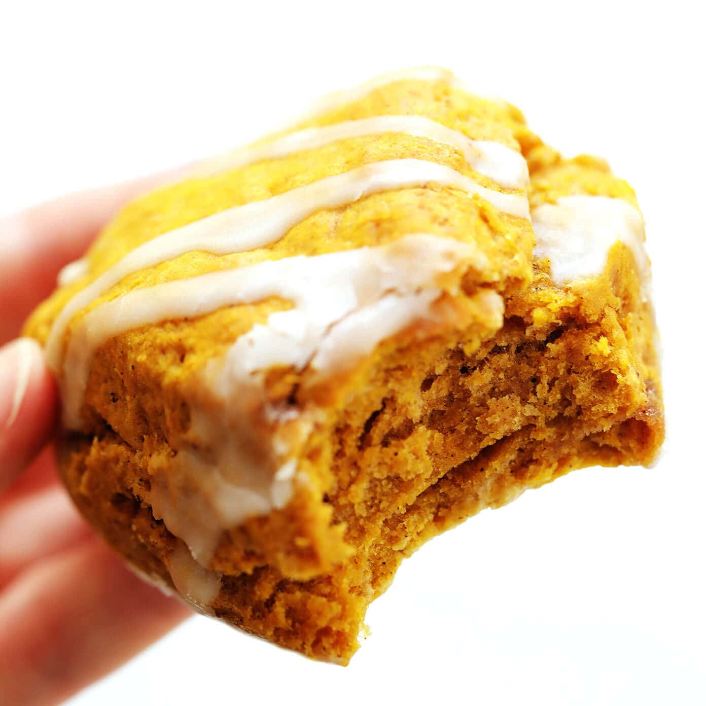 This pumpkin scones recipe is quick and easy to make, drizzled with a light vanilla glaze, and full of the best cozy pumpkin flavors. The perfect fall treat for breakfast, brunch, snack or dessert. | gimmesomeoven.com #pumpkin #scone #breakfast #brunch #dessert #treat #vanilla #glaze #icing #easy Pumpkin Scone Closeup