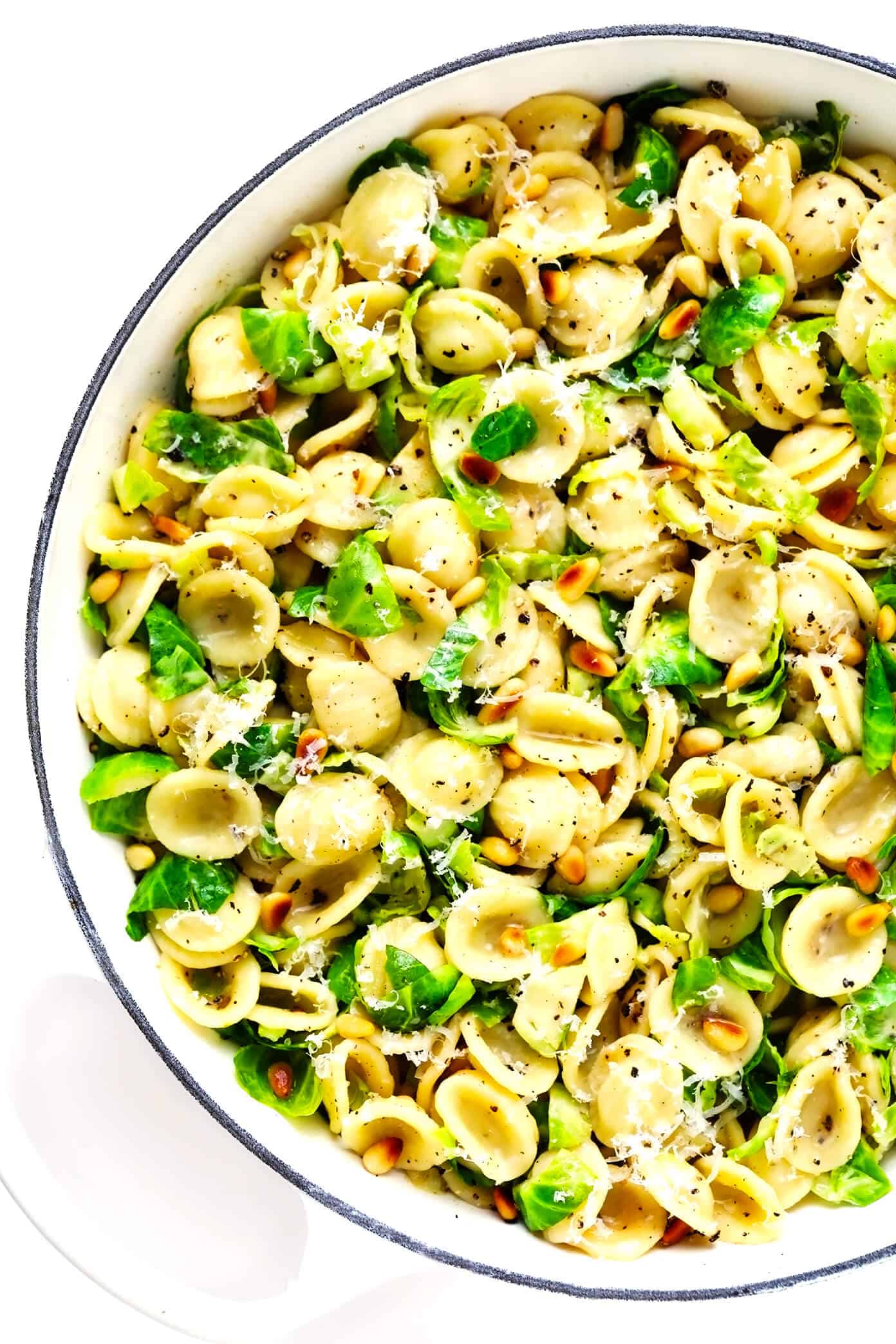 This 30-Minute Brussels Sprouts Parmesan Pasta is made with garlicky shredded Brussels sprouts, toasted pine nuts, and a silky cacio e pepe style cheese and black pepper sauce. It's the perfect easy dinner recipe for fall and winter, and tastes SO delicious. | gimmesomeoven.com #pasta #brussels #vegetarian #italian #cacioepepe #parmesan #sauce #dinner Brussels Sprouts Parmesan Pasta with Pine Nuts in Sauté Pan