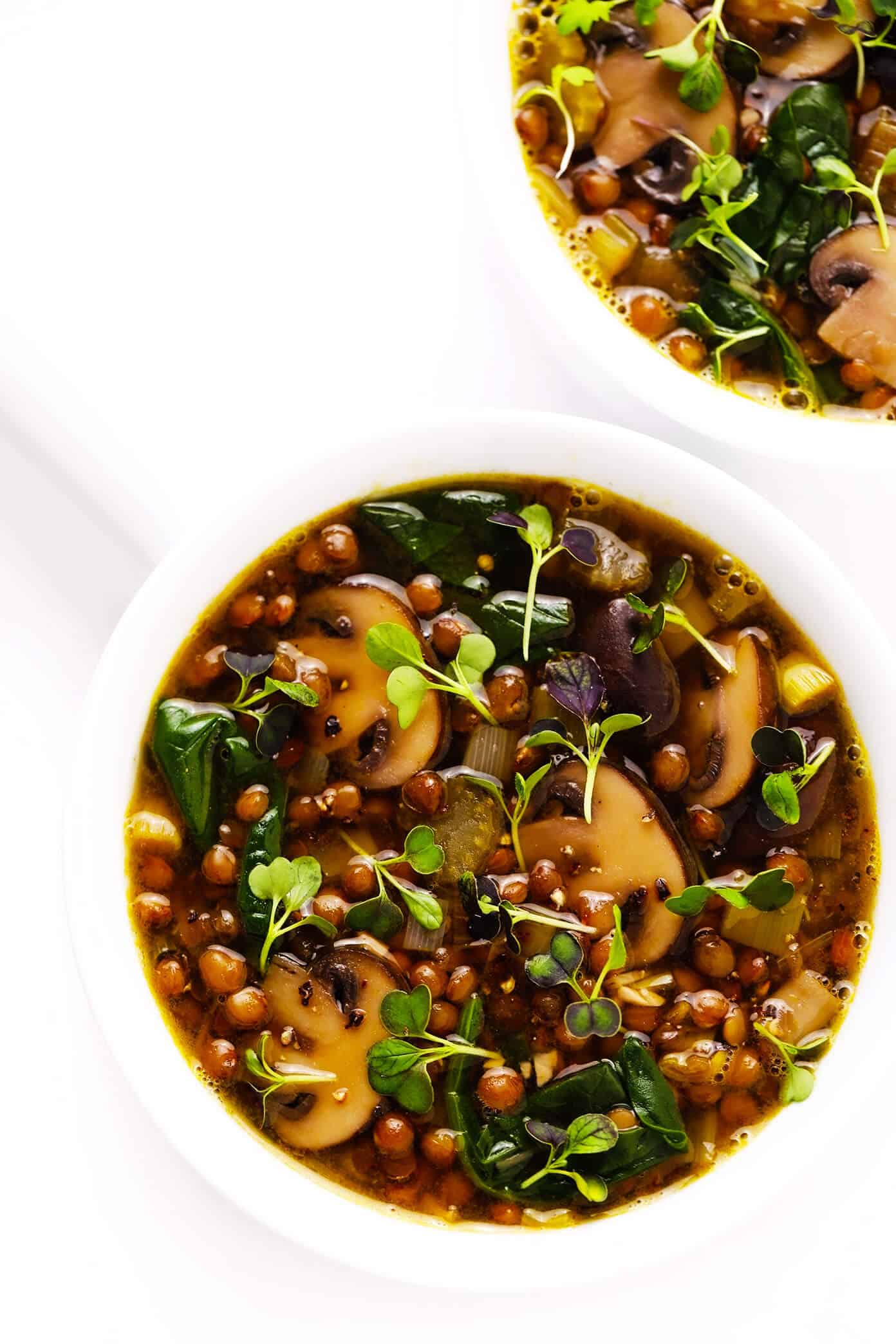 This simple French Lentil and Mushroom Soup recipe is simmered with the most delicious blend of veggies, herbs and greens. It's healthy yet hearty, naturally vegan and gluten-free, and total comfort food. | gimmesomeoven.com #french #soup #stew #lentil #mushroom #healthy #dinner #glutenfree #vegetarian #vegan French Lentil and Mushroom Soup Recipe in Bowls