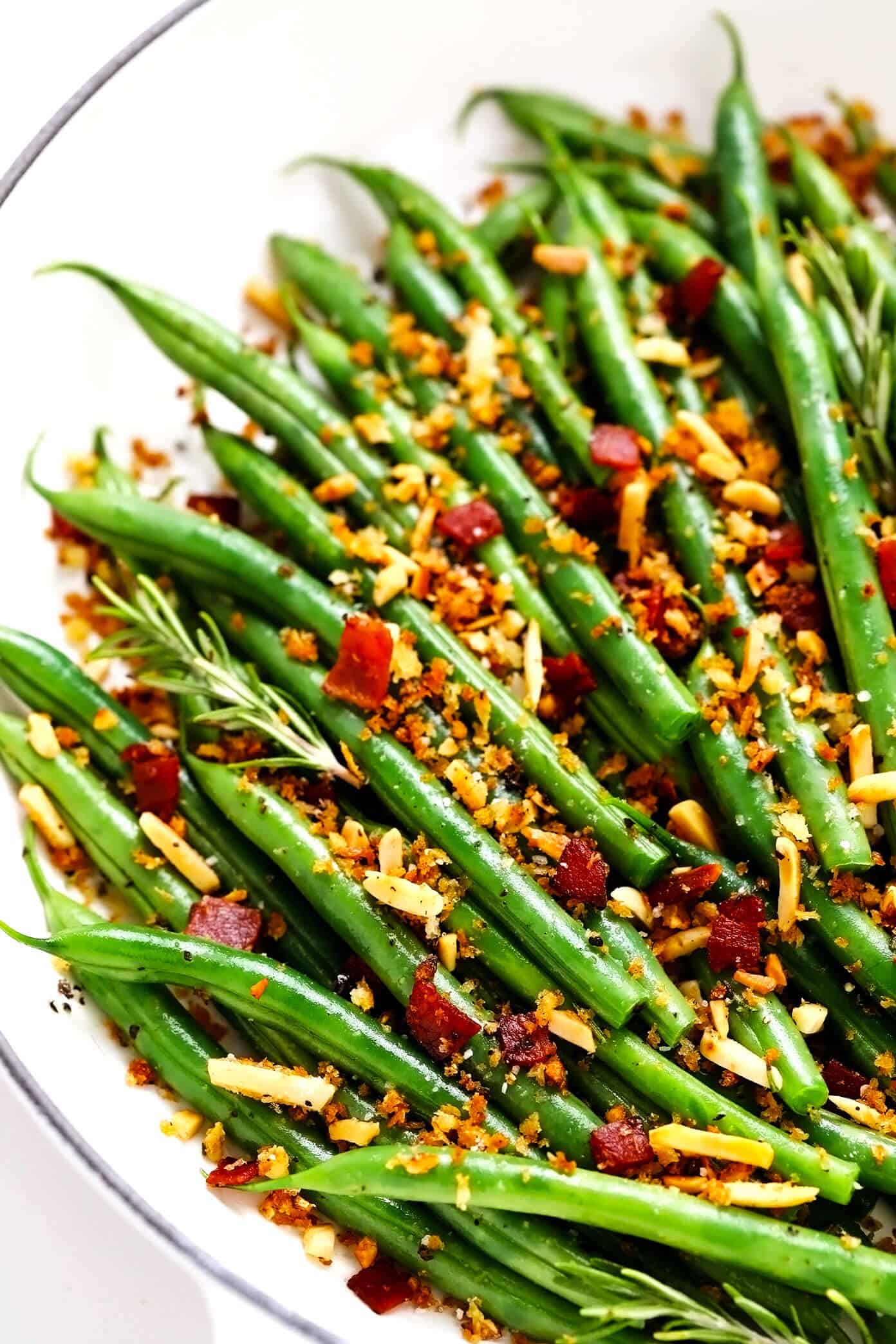 This one-pan sautéed green beans recipe is quick and easy to make and tossed with the most irresistible crispy garlic almond rosemary bacon breadcrumbs. The perfect easy side dish for Thanksgiving, Christmas, or any weeknight dinner! | gimmesomeoven.com #greenbeans #vegetable #side #bacon #thanksgiving #christmas #holiday #glutenfree #dinner Green Beans with Rosemary Bacon Breadcrumbs in Saute Pan