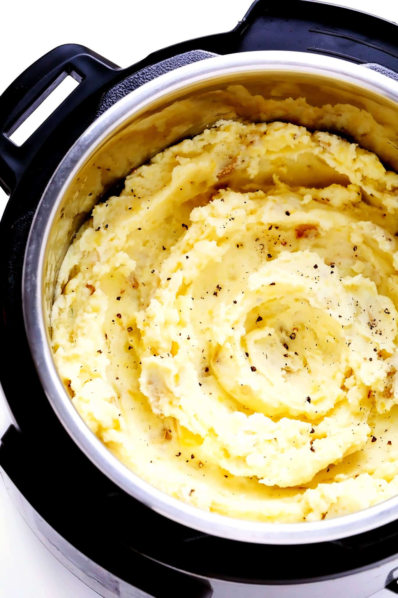 This Instant Pot Mashed Potatoes recipe is incredibly easy to make (no draining required), perfectly creamy and fluffy, and always so buttery and delicious! Feel free to add in extra garlic, cheese, herbs, or any other seasonings that sound good too. | gimmesomeoven.com #instantpot #pressurecooker #mashed #potatoes #side #thanksgiving #christmas #dinner #vegetarian #glutenfree #vegan Mashed Potatoes In The Instant Pot