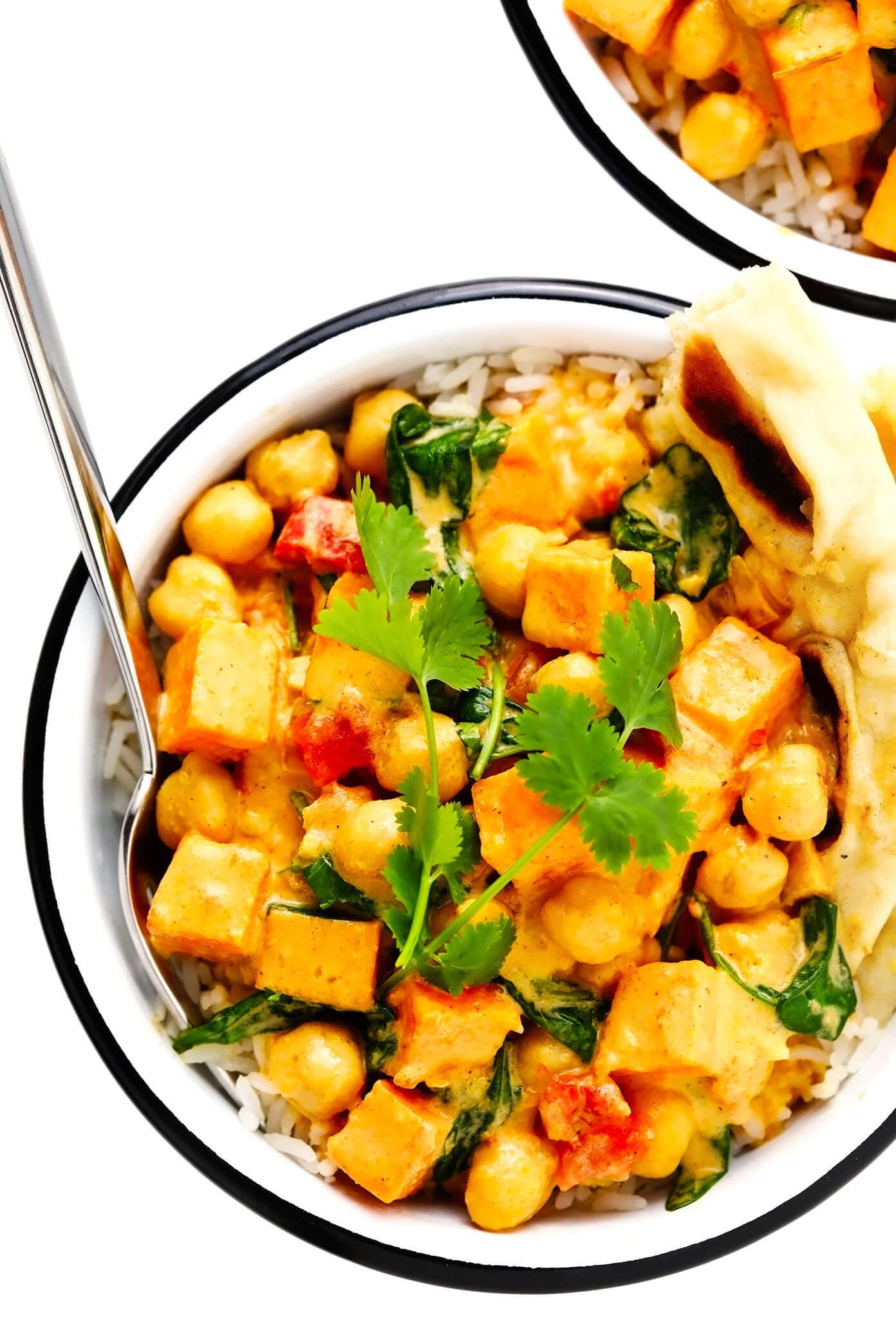 This delicious Sweet Potato Chickpea Coconut Curry recipe is super easy to make, naturally gluten-free, vegetarian and vegan, and it's simmered with tomatoes, garlic, ginger, spinach the coziest creamy coconut curry broth. Goes great with rice and/or naan bread, and tastes amazing for leftovers the next day! | gimmesomeoven.com #curry #healthy #vegetable #vegetarian #vegan #glutenfree #chickpea #sweetpotato #dinner #mealprep #indian Sweet Potato Chickpea Coconut Curry in Bowl with Naan Bread and Rice