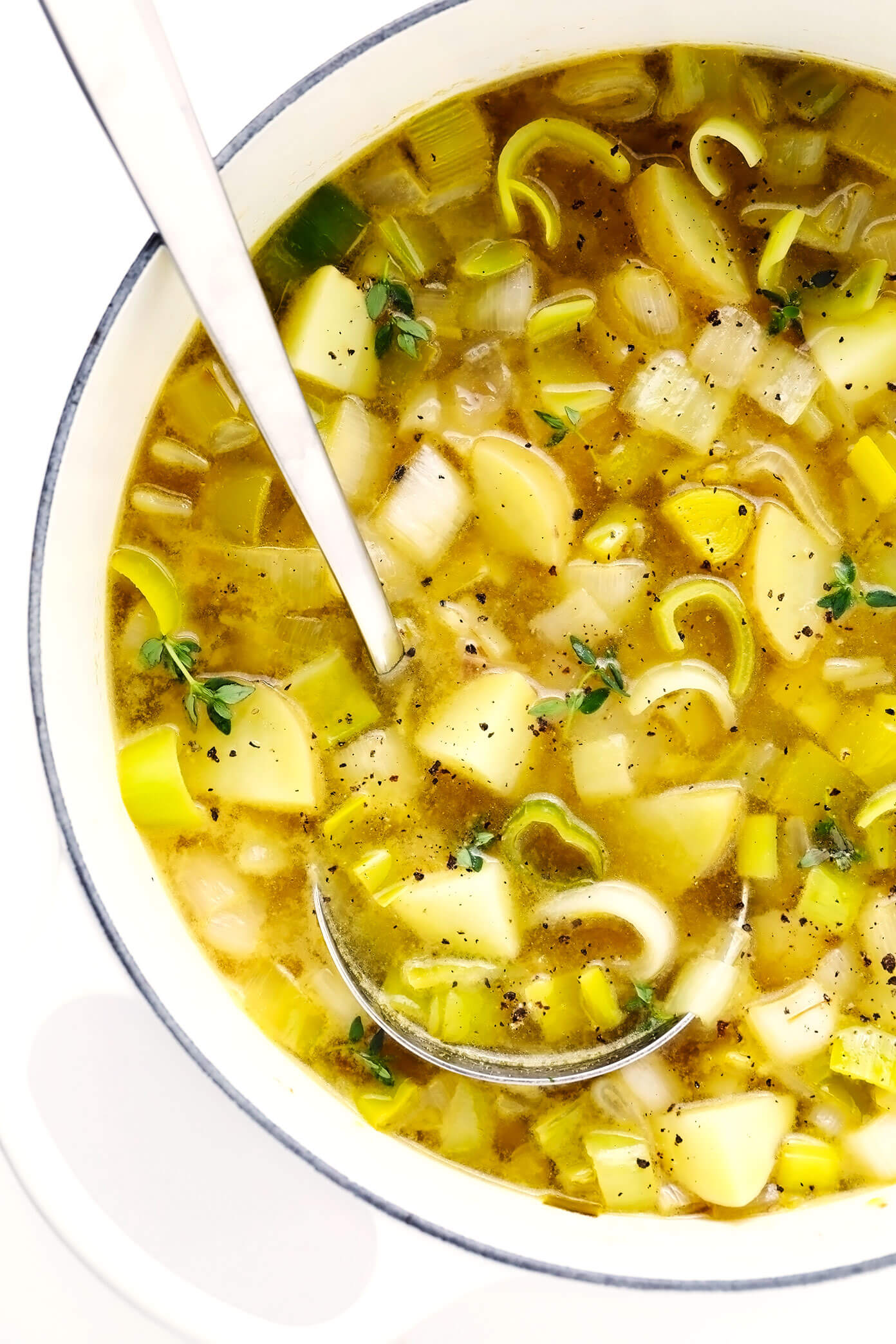 This Rustic Potato Leek Soup is easy to make in about 35 minutes, it's naturally gluten-free, vegetarian, vegan, and it's made with the most delicious, light, garlic-herb broth. A quick, easy and healthy dinner recipe that's always so comforting! (Feel free to add croutons or a sprinkle of Parmesan cheese too!) | gimmesomeoven.com #soup #potato #leek #french #onion #healthy #glutenfree #vegetarian #vegan #dinner #mealprep Rustic Potato Leek Soup in Stockpot