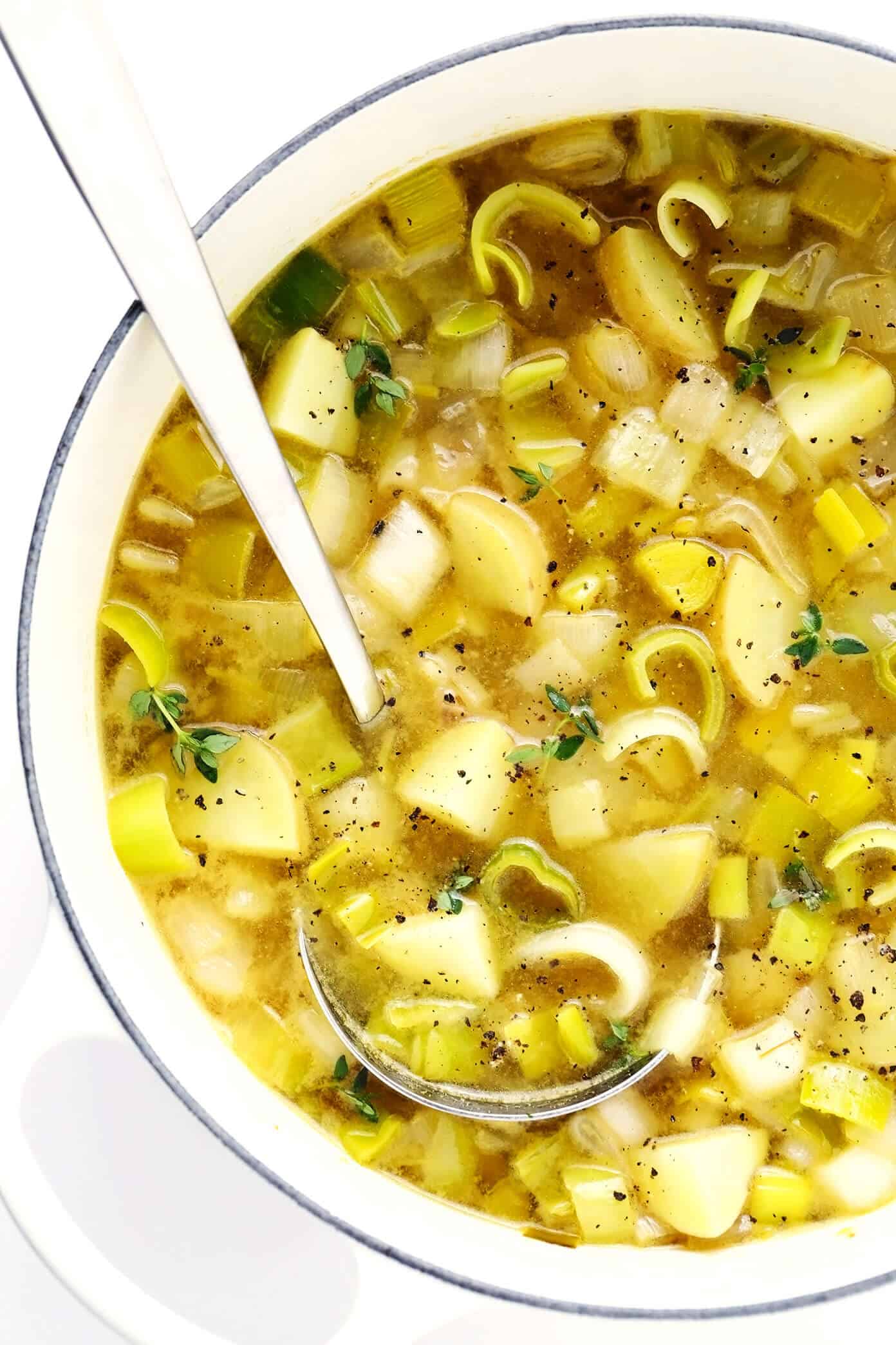 This Rustic Potato Leek Soup is easy to make in about 35 minutes, it's naturally gluten-free, vegetarian, vegan, and it's made with the most delicious, light, garlic-herb broth. A quick, easy and healthy dinner recipe that's always so comforting! (Feel free to add croutons or a sprinkle of Parmesan cheese too!) | gimmesomeoven.com #soup #potato #leek #french #onion #healthy #glutenfree #vegetarian #vegan #dinner #mealprep Rustic Potato Leek Soup