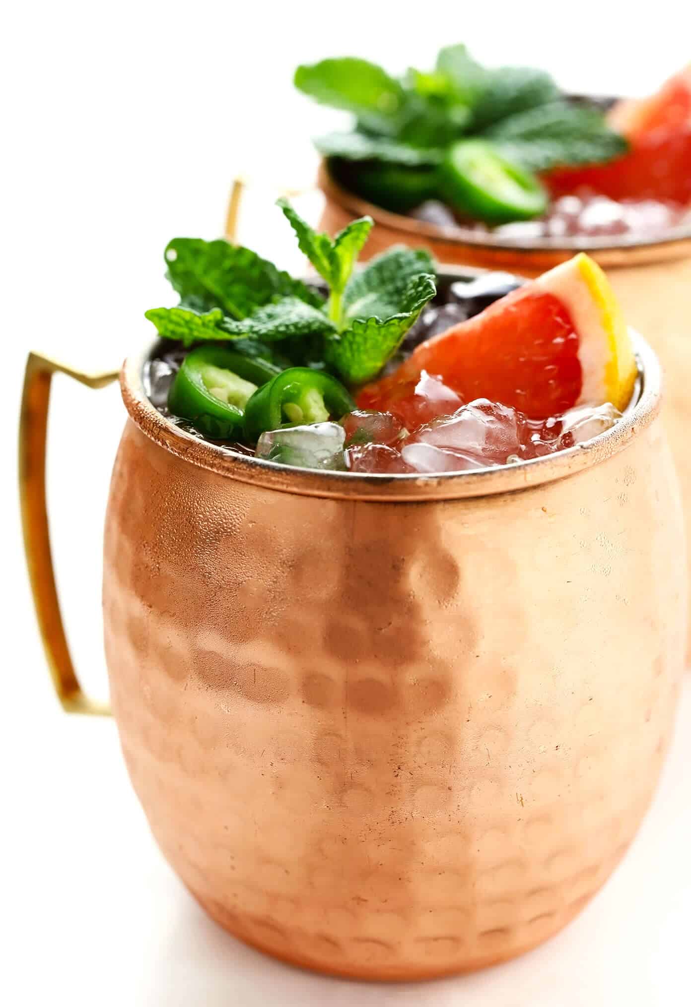 This Spicy Grapefruit Ginger Fizz mocktail is made with grapefruit juice, spicy ginger beer, fresh lime juice, mint, and jalapeño. It's easy to whip up in 5 minutes, minimally sweet, and so flavorful! | gimmesomeoven.com #mocktail #drink #gingerbeer #alcoholfree #grapefruit #spritzer Spicy Grapefruit Ginger Fizz Mocktails Side By Side