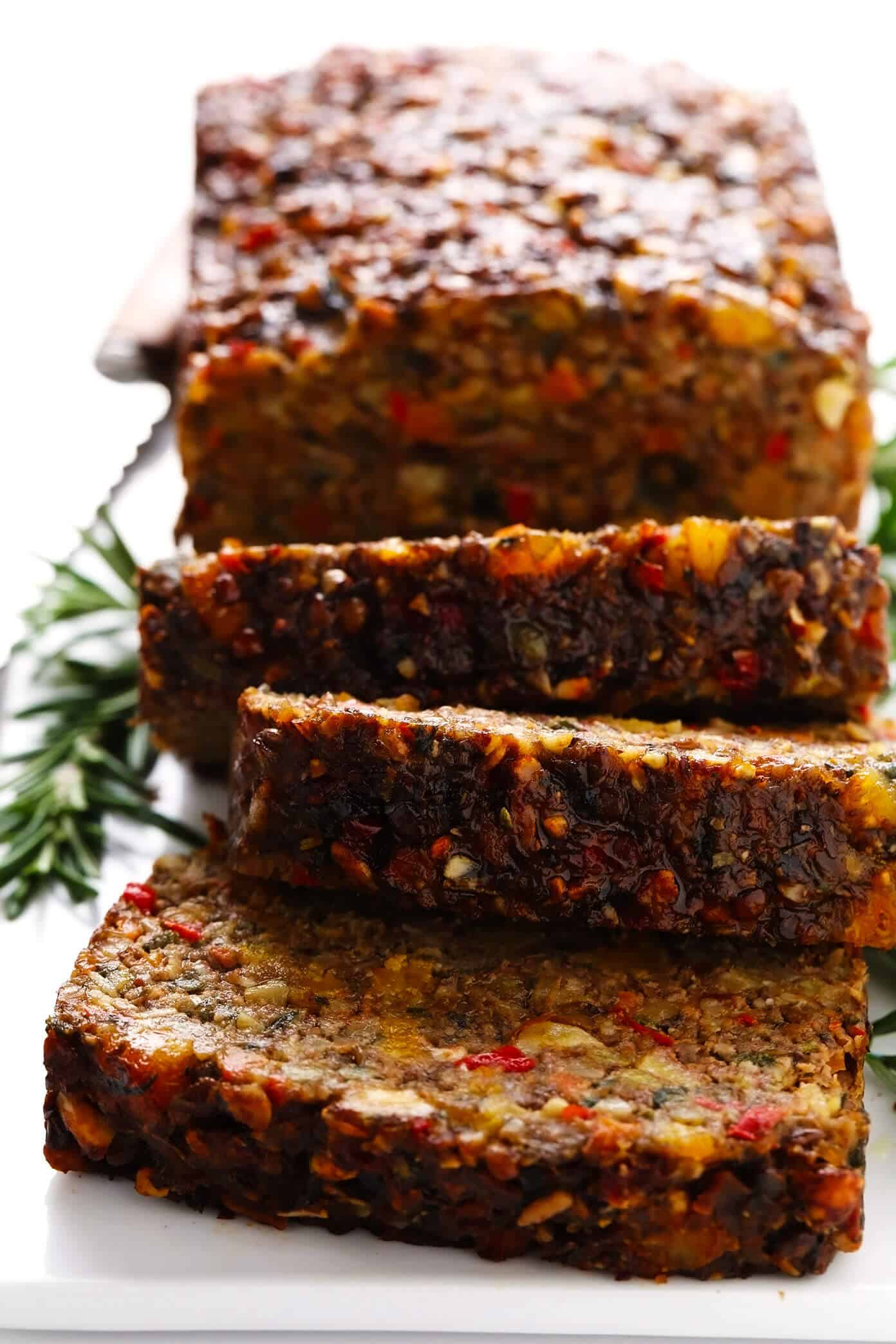 This Nut Roast recipe is packed with a deliciously sweet and savory blend of nuts, veggies, lentils, dried apricots and fresh rosemary and sage. It's easy to prep in advance, naturally gluten-free + vegetarian + vegan, and absolutely delicious served with cranberry sauce and/or gravy. Perfect for the holidays (especially Christmas, Thanksgiving or Easter) or Sunday dinner! | gimmesomeoven.com #nutroast #vegetarian #vegan #glutenfree #healthy #dinner #christmas #holiday Sliced Nut Roast