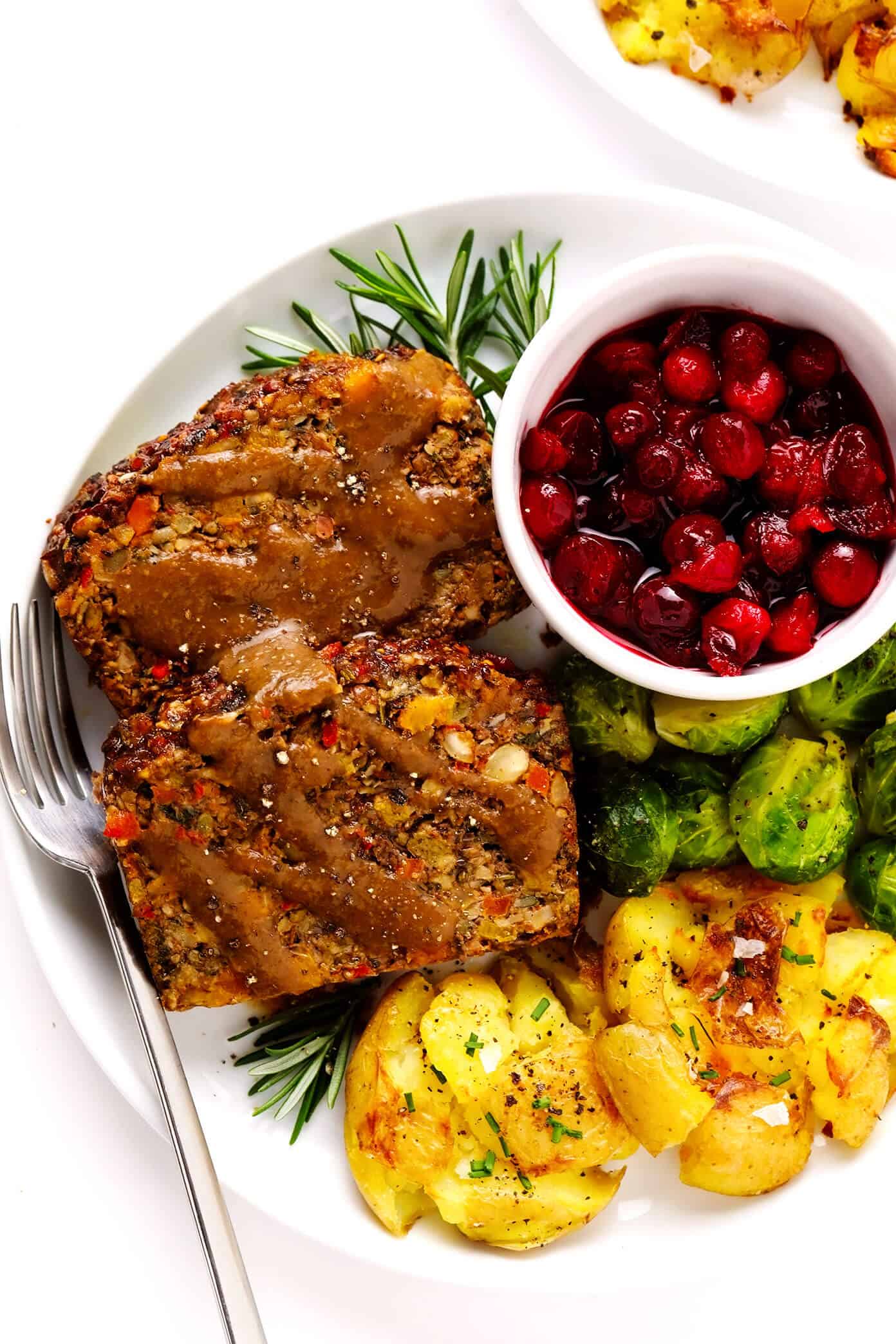 This Nut Roast recipe is packed with a deliciously sweet and savory blend of nuts, veggies, lentils, dried apricots and fresh rosemary and sage. It's easy to prep in advance, naturally gluten-free + vegetarian + vegan, and absolutely delicious served with cranberry sauce and/or gravy. Perfect for the holidays (especially Christmas, Thanksgiving or Easter) or Sunday dinner! | gimmesomeoven.com #nutroast #vegetarian #vegan #glutenfree #healthy #dinner #christmas #holiday Nut Roast with Gravy, Smashed Potatoes, Roasted Brussels Sprouts and Cranberry Sauce